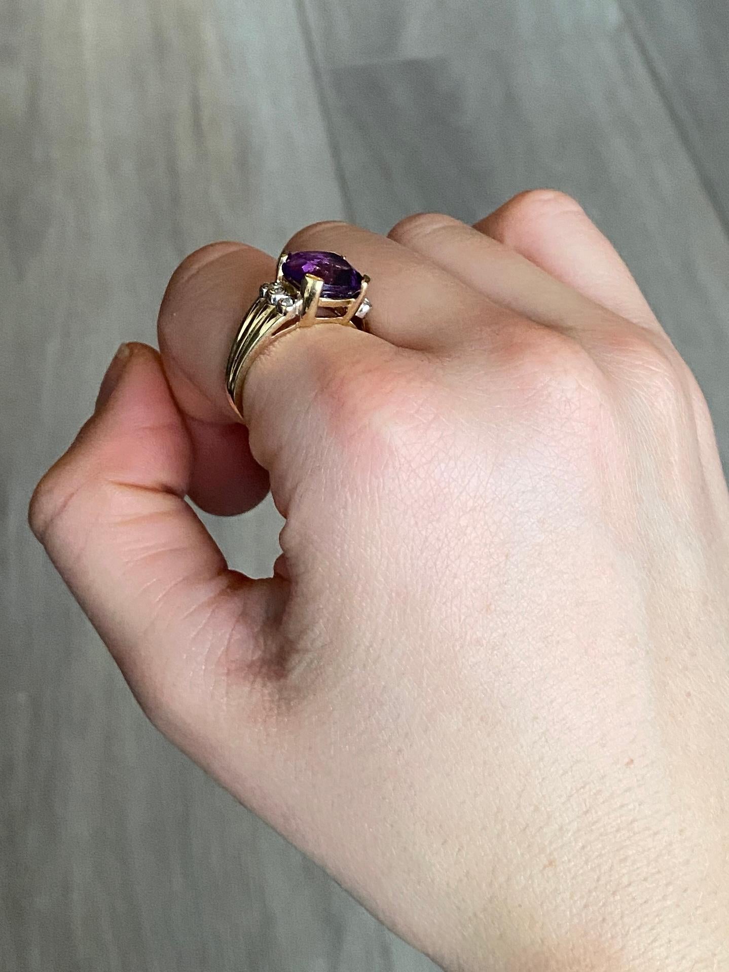The amethyst stone in this ring is bright and a gorgeous colour. There are two trios of diamonds that sit either side of the central stone. Diamond total 20pts. Modelled in 9carat gold. Amethyst dimensions 10x10mm.

Ring Size: N or 6 3/4 
Height Off