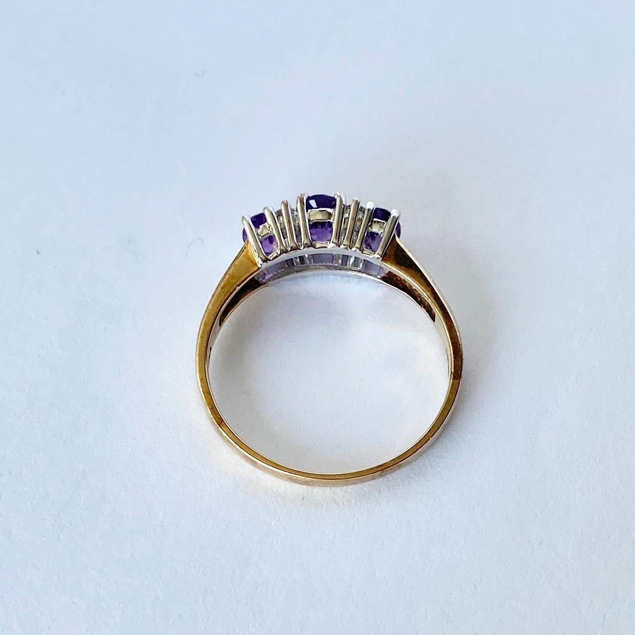 The amethyst stones in this ring are so bright and a gorgeous colour. There are two pairs of diamonds that sit either side of the central stone. Diamond total 15pt and amethyst total 70pts. Modelled in 9carat gold. 

Ring Size: O 1/2 or 7 1/2
Height