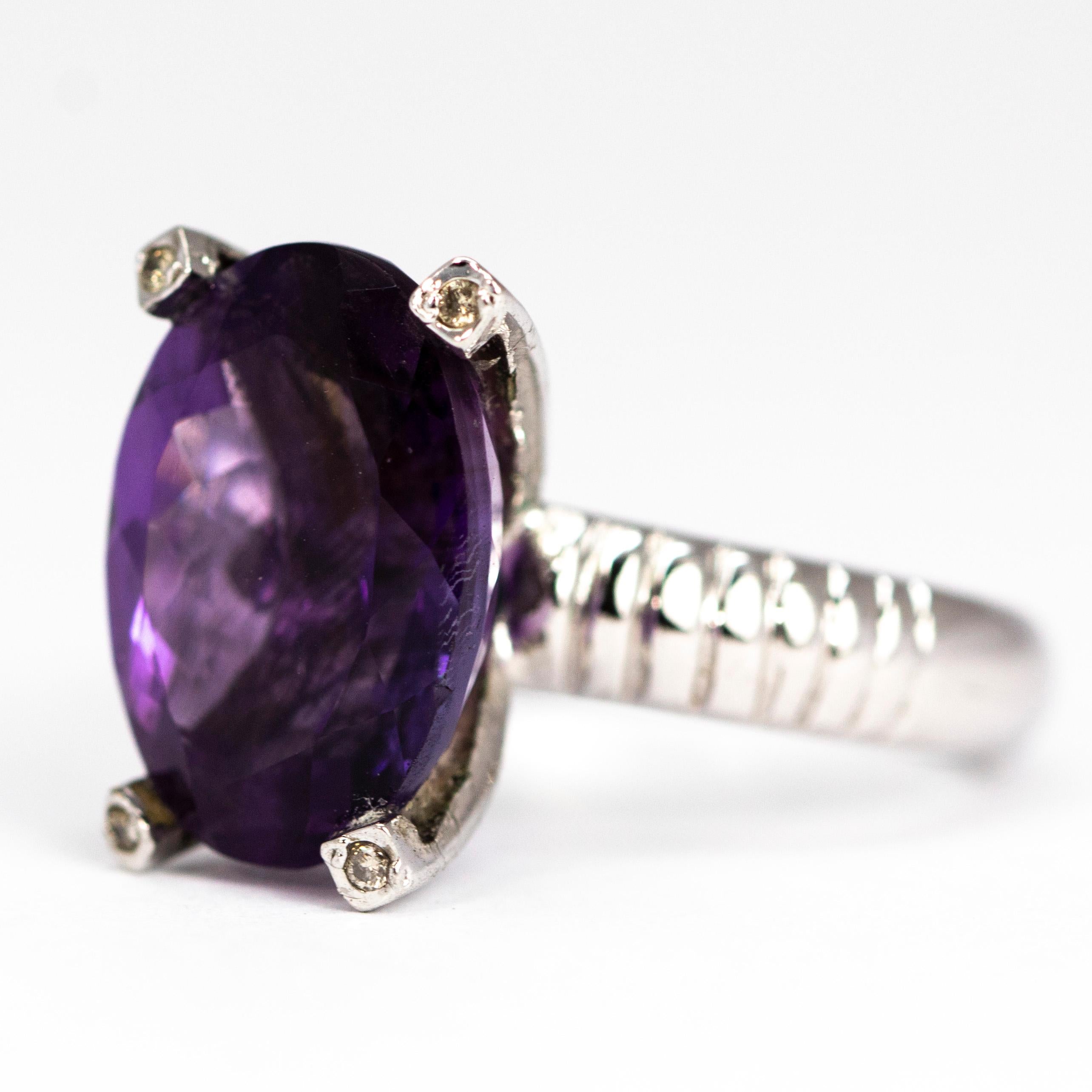 This stunning amethyst sits proudly on a simple four claw setting modelled out of silver and has ribbed shoulders. On the tip of each claw is a diamond point which adds a lovely bit of sparkle. 

Ring Size: P 1/2 or 8
Stone Dimensions: 11 x 16.5mm