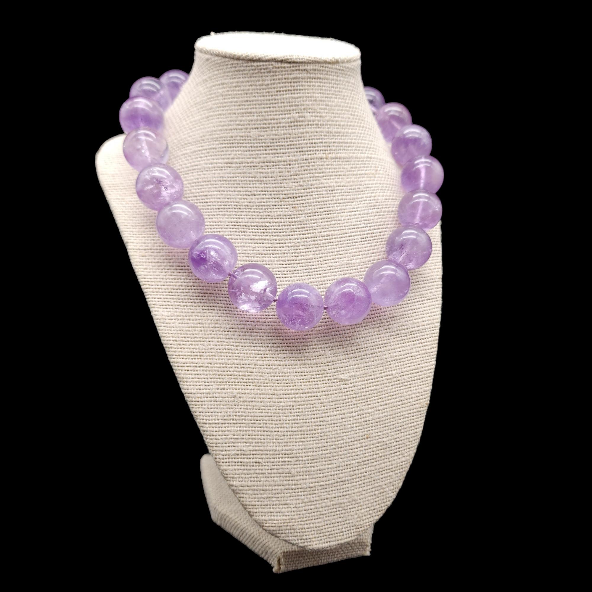 A simple, yet bold, amethyst bead necklace on a knotted string. Features a sterling silver clasp.

Necklace is approximately 17 and 1/4 inches or 44cm. 

Each bead is approximately 3/4 inches.

Marks / Hallmarks / Etc. : 925