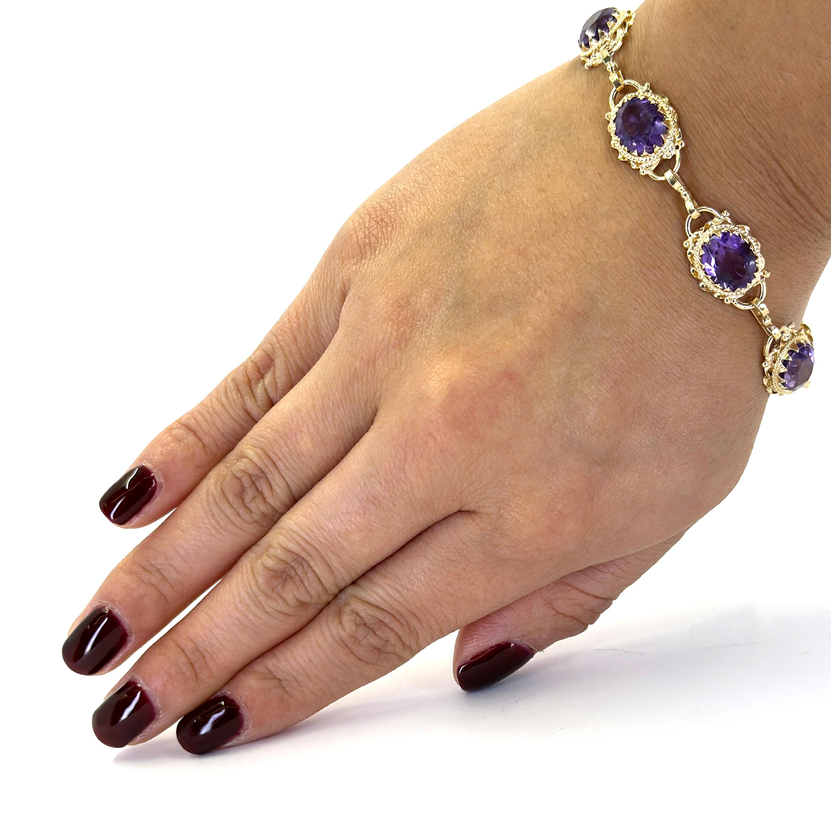 14 Karat Yellow Gold Ornate Bracelet Featuring 7 Oval Amethysts Totaling Approximately 19 Carats. 7.25 Inches Long with Spring Ring Clasp. Finished Weight is 14.3 Grams.