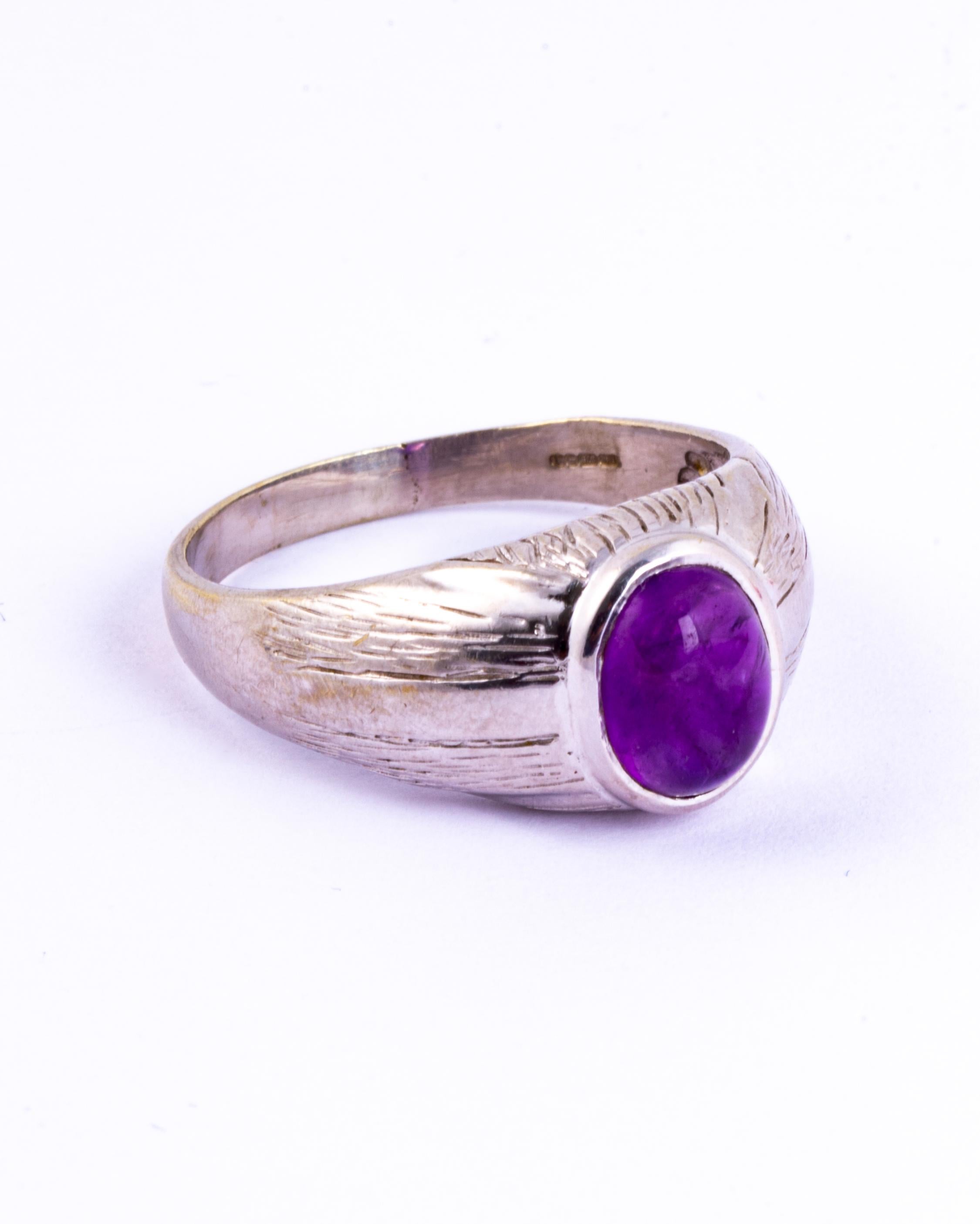 This chunky white gold band holds a stunning amethyst Cabochon. The ring stands quite high on the finger and is a real statement piece. The extra wide 9ct white gold band goes perfectly with the tall stone.

Ring Size: Y 1/2 or 12 1/4 
Band Width: