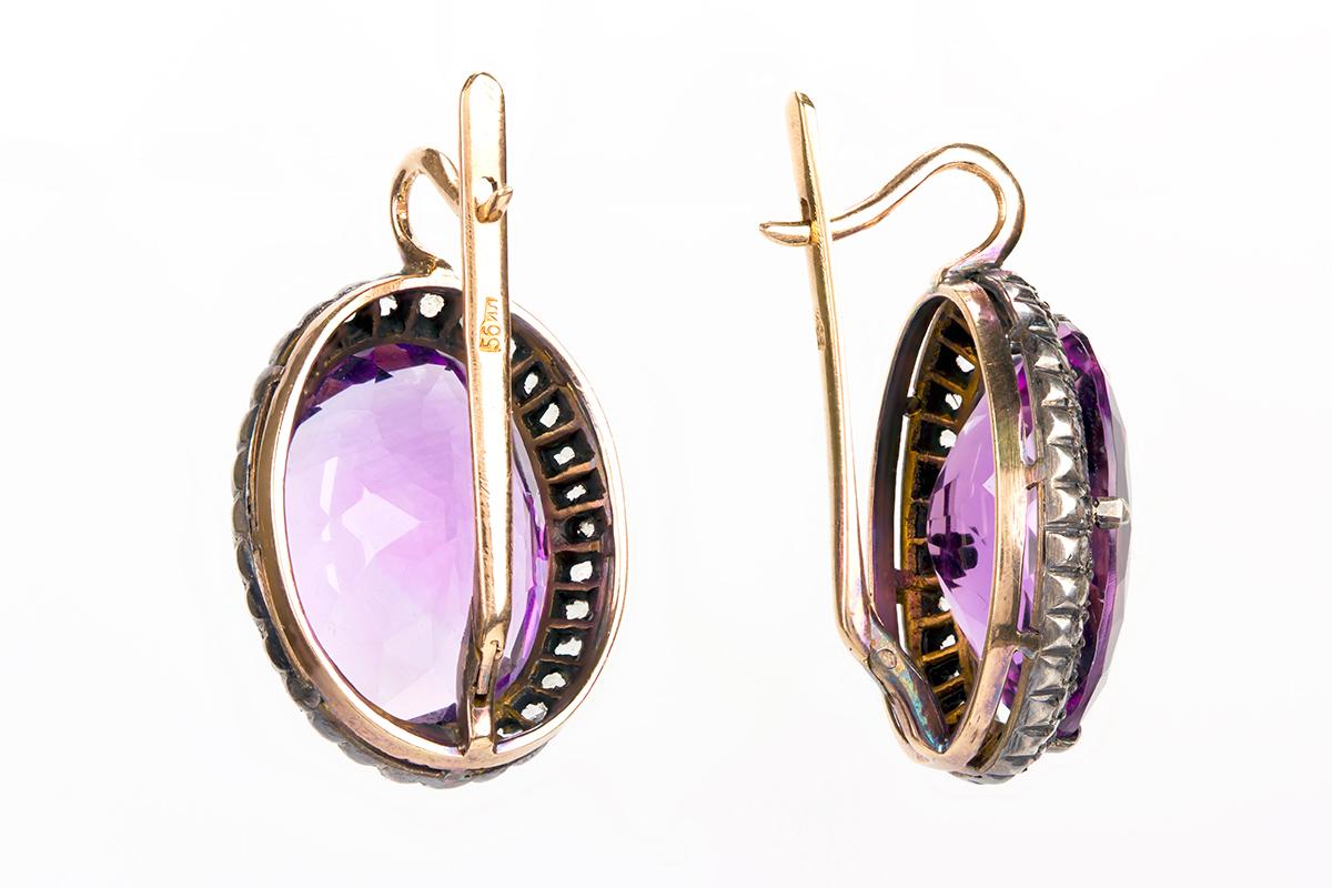 Vintage cluster earrings of fine coloured oval amethyst with a rose cut diamond surround. The amethysts are particularly well matched and have a fine brilliance. The stones are set in 18 karat yellow gold and sterling silver with Russian marks on