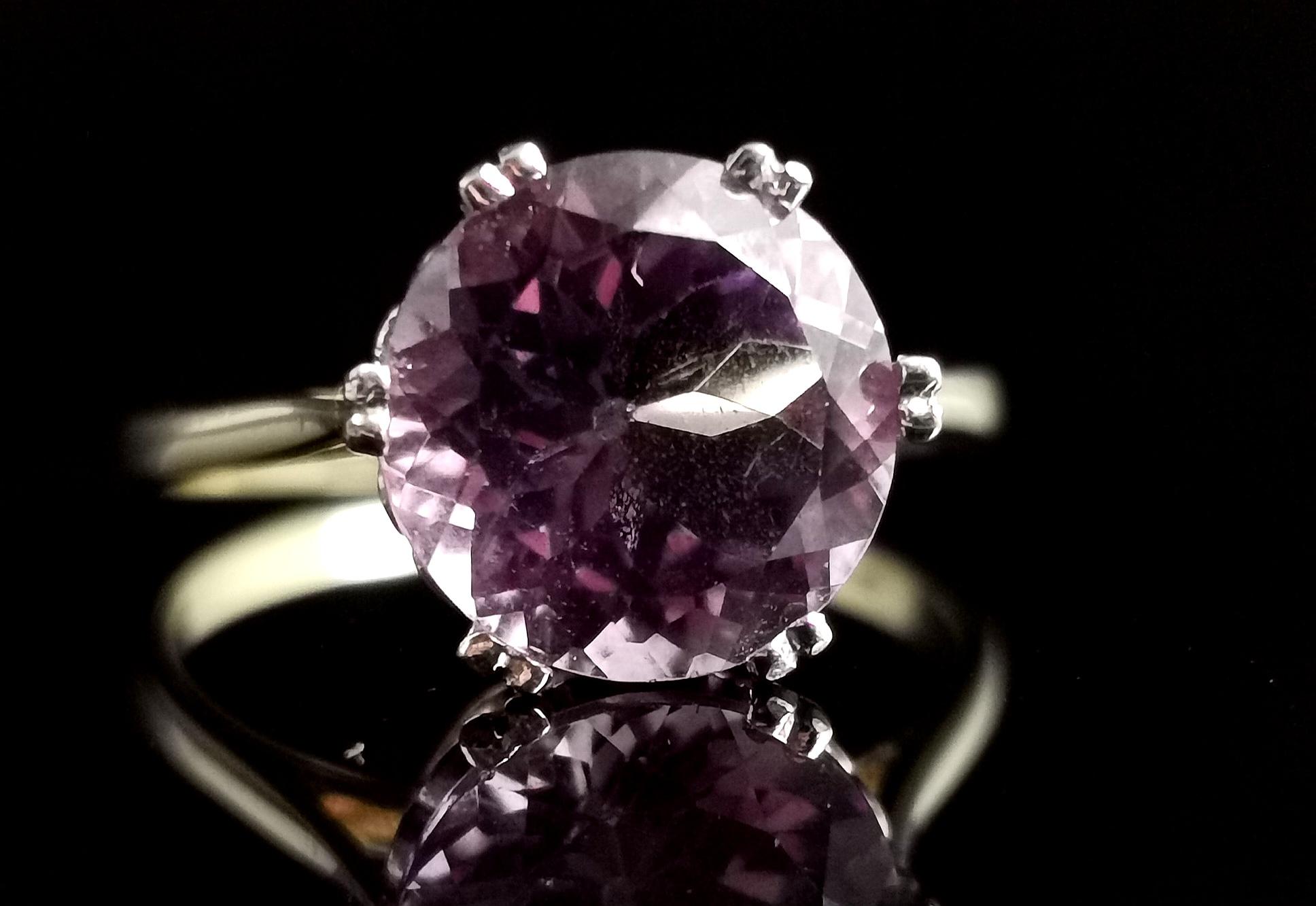 A Gorgeous vintage Amethyst cocktail ring.

A beautiful mid to deep purple round cut Amethyst with approx 3ct weight, it is the stone that steals the show on this ring and it has a high profile from the finger.

It has a smooth 9kt yellow gold band