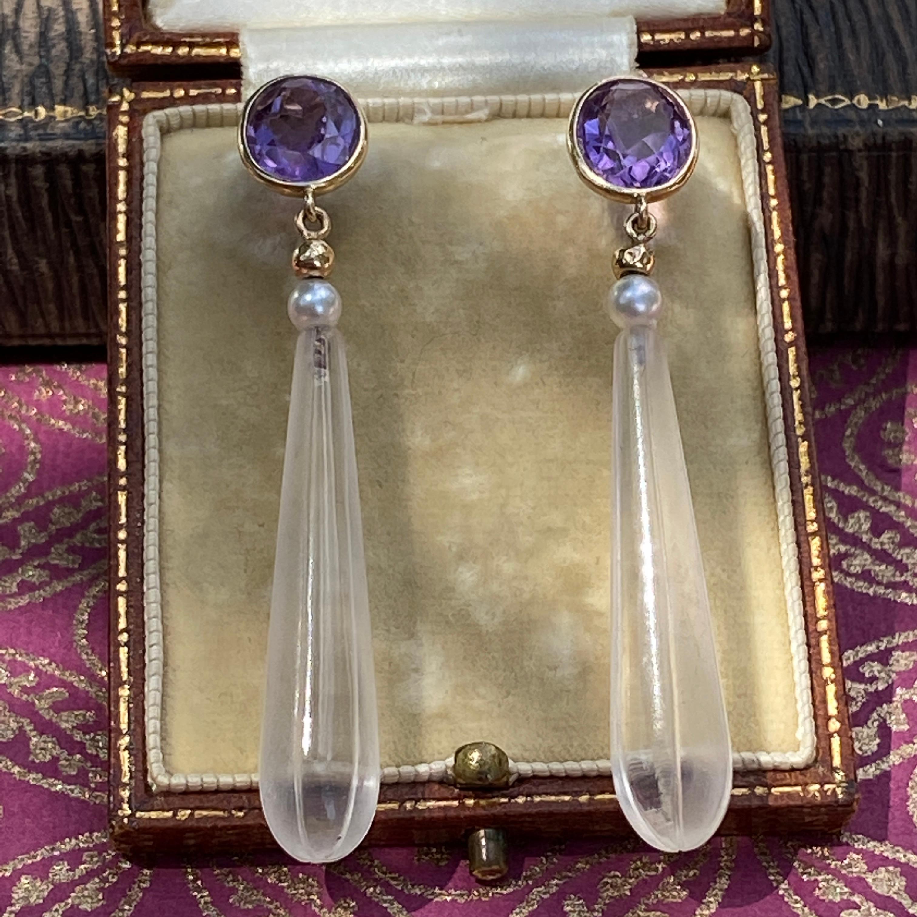 Details:
Beautiful vintage amethyst, rock crystal and pearl earrings set in 14K yellow gold. The round, faceted, natural amethyst are a lovely rich purple color, and the rock crystal drops have etched striping that adds dimension to the lovely