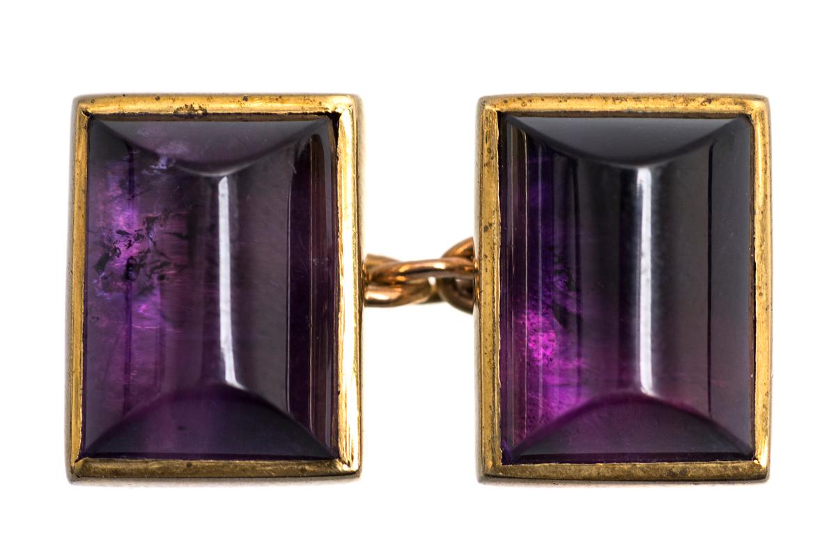 A vintage pair of double sided cufflinks of single amethysts in a close backed setting. Mounted in 9 carat yellow gold with chain link connections. Hallmarked 9ct Birmingham 1997.
Measures 14mm in height x 10mm in width.
Vintage piece in the