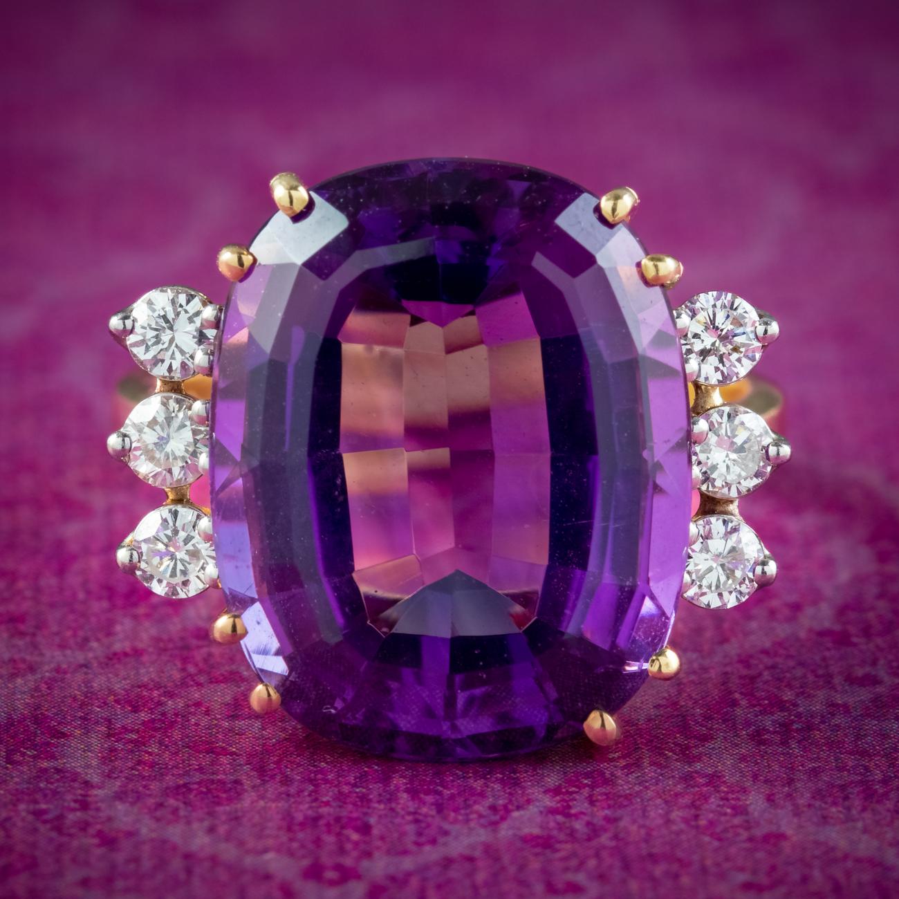 Boasting an enormous cushion cut amethyst, this spectacular mid-Century cocktail ring was made to be seen! The amethyst weighs approx. 16 carats and has a luxurious, deep purple hue and an array of glistening facets, complemented beautifully by