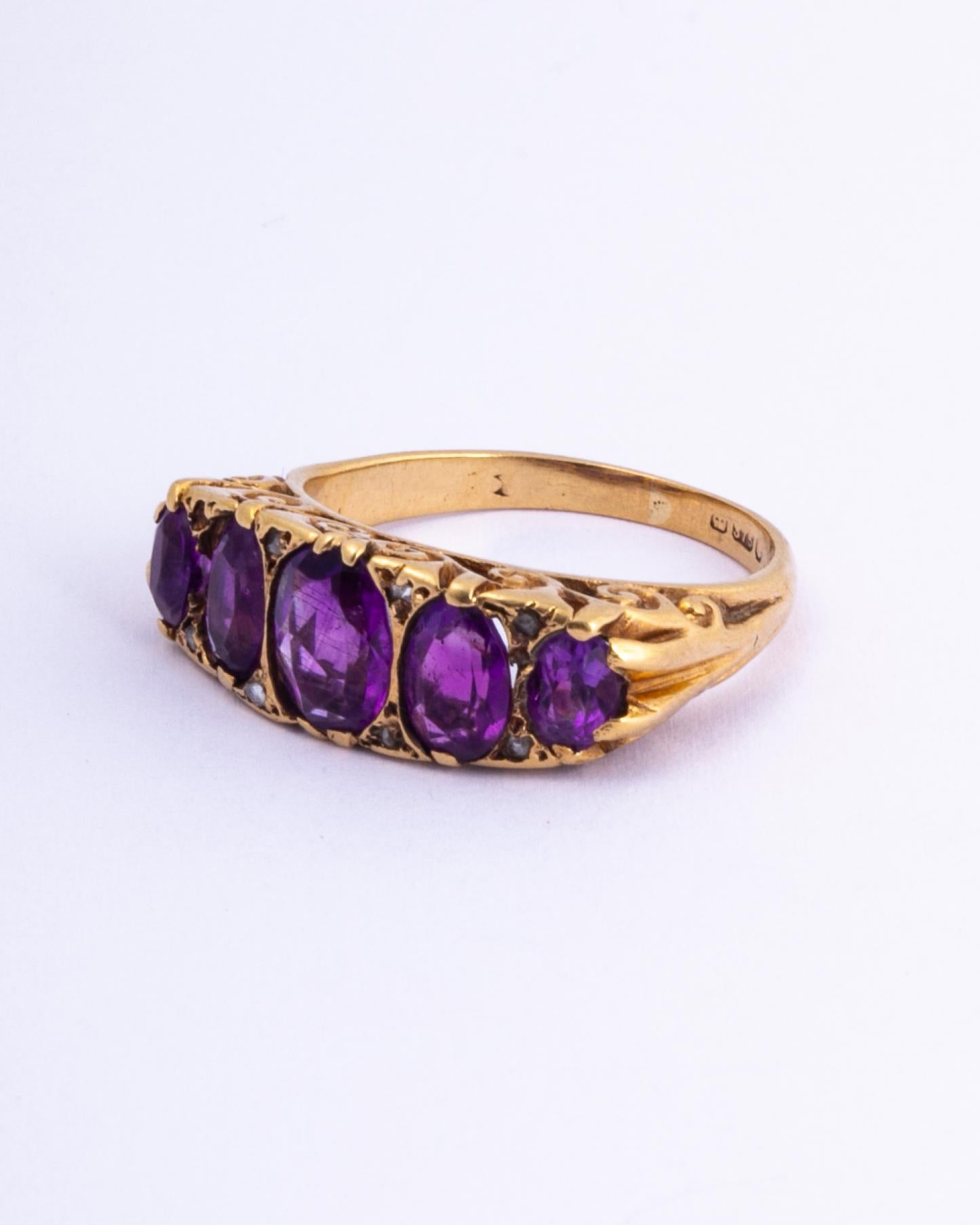 Not only does this ring hold five bright and sparkling amethyst but it also boasts diamond points. All stone are set in gold and have an ornate gallery. Even the shoulders on this ring have the swirl detail.

Ring Size: M or 6 1/4
Band Width (widest
