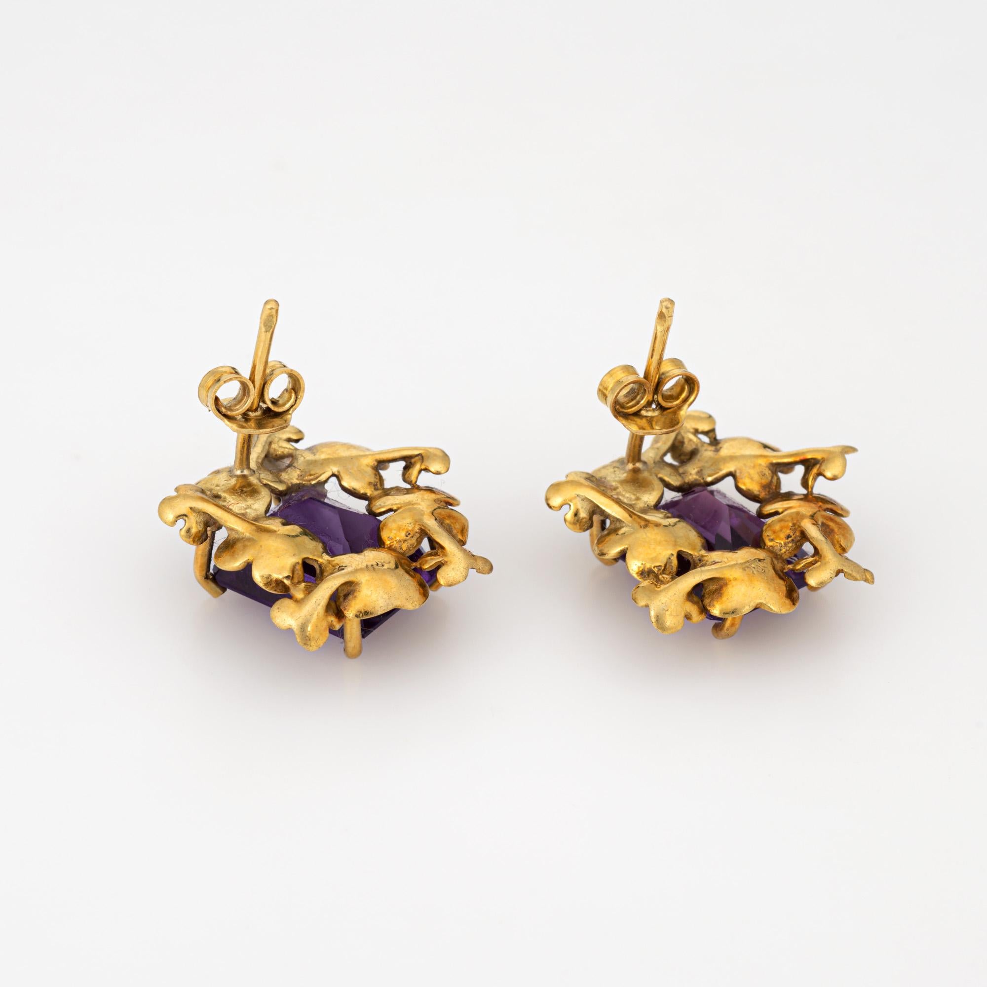 Finely detailed pair of vintage amethyst flower earrings crafted in 18k yellow gold. (circa 1960s to 1970s). 

Emerald cut amethysts measure 11mm x 9mm (estimated at 3.50 carats each - 7 carats total estimated weight). 
The sweet earrings feature a