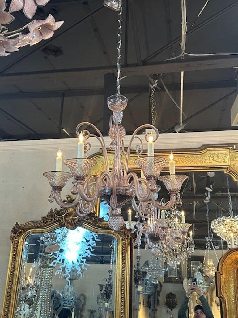Gorgeous vintage Murano amethyst glass brass twist arm chandelier. Circa 1970. The chandelier has been professionally rewired, comes with matching chain and canopy. It is ready to hang!