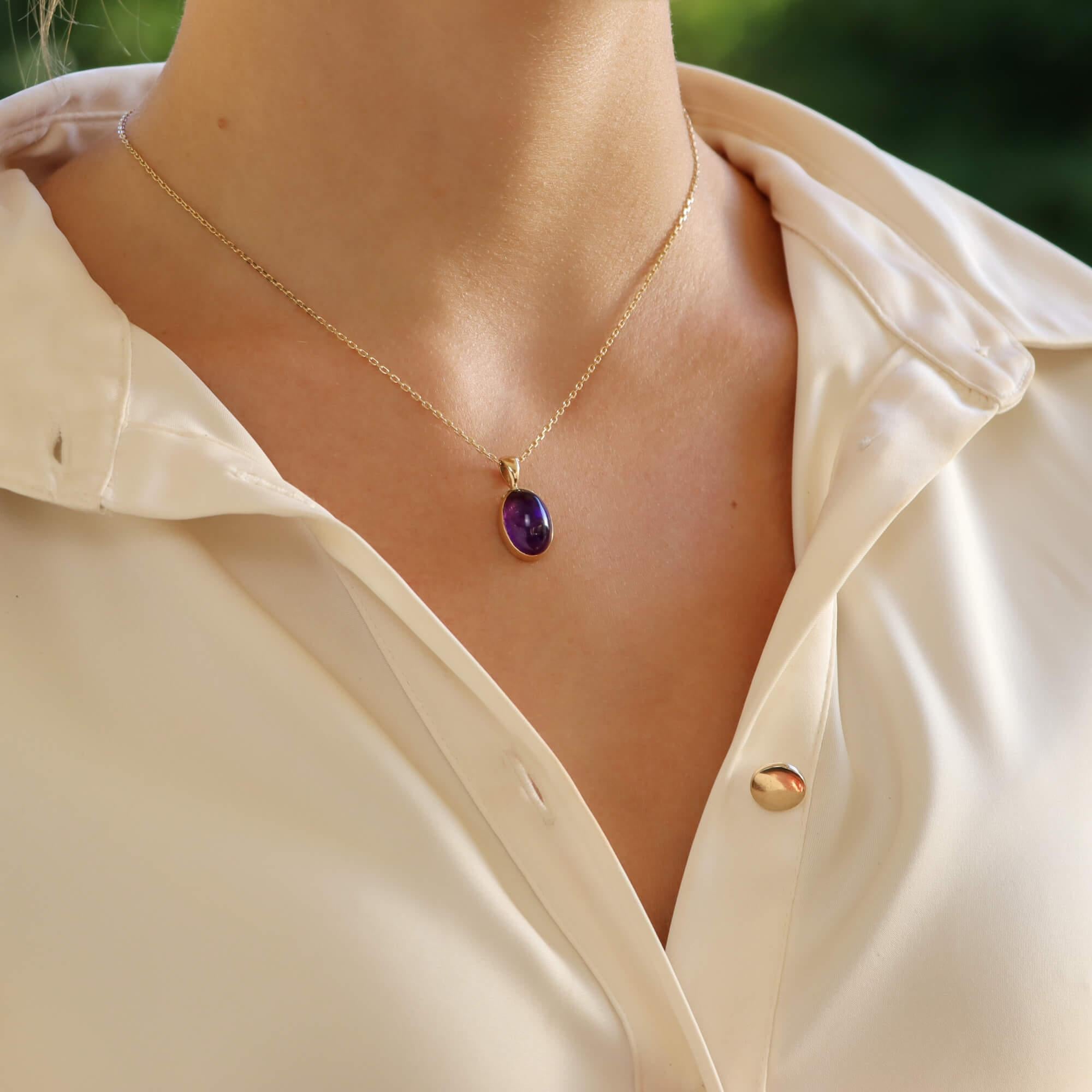 A beautiful amethyst pendant set in 9k yellow gold.

The pendant solely features a lovely vibrant purple amethyst stone, simply rub over set in a 9k yellow gold mount. The pendant hangs from a matching 9k yellow gold trace chain. The chain measures
