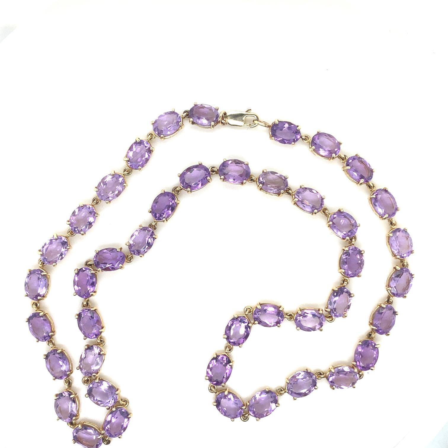A vintage amethyst riviere necklace in 9 karat yellow gold, circa 1980.

This elegant and classic riviere necklace features 42 individually set oval cut amethysts for a total of 37 carats approximately. Each amethyst is mounted within a four claw