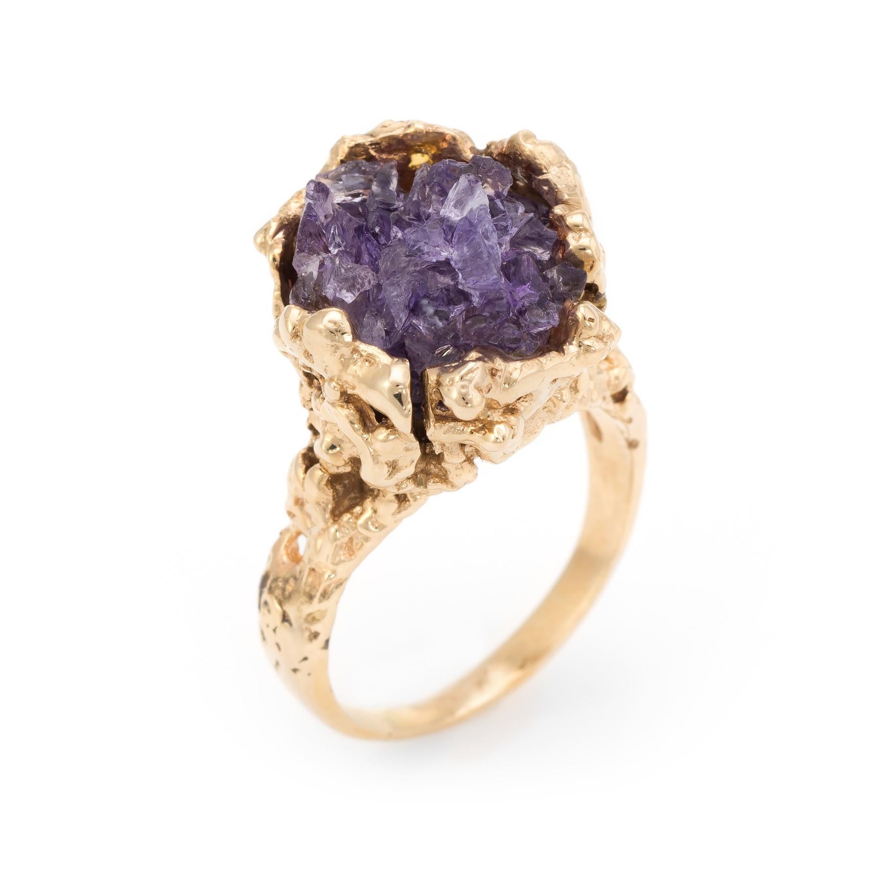 Distinct and unusual vintage nugget cocktail ring (circa 1960s to 1970s), crafted in 14 karat yellow gold. 

An amethyst specimen in natural form measures 14mm x 12mm. The bold and rustic charm of the amethyst is perfectly complimented with the