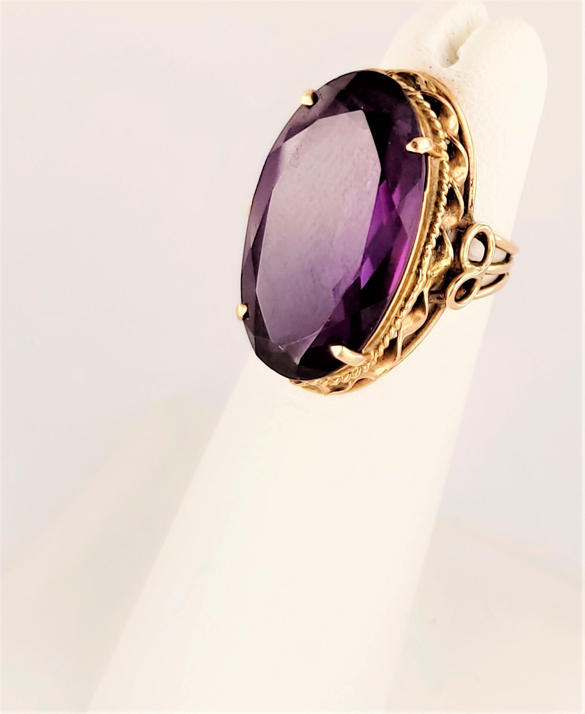 This beauty has a large center oval cut Amethyst.
Make a statement! Make it yours today!

Material: 14k Yellow Gold
Weight 6.9
Size: 3.5
Height: 7mm
Stone Dimensions: 21.5 x 12.1
