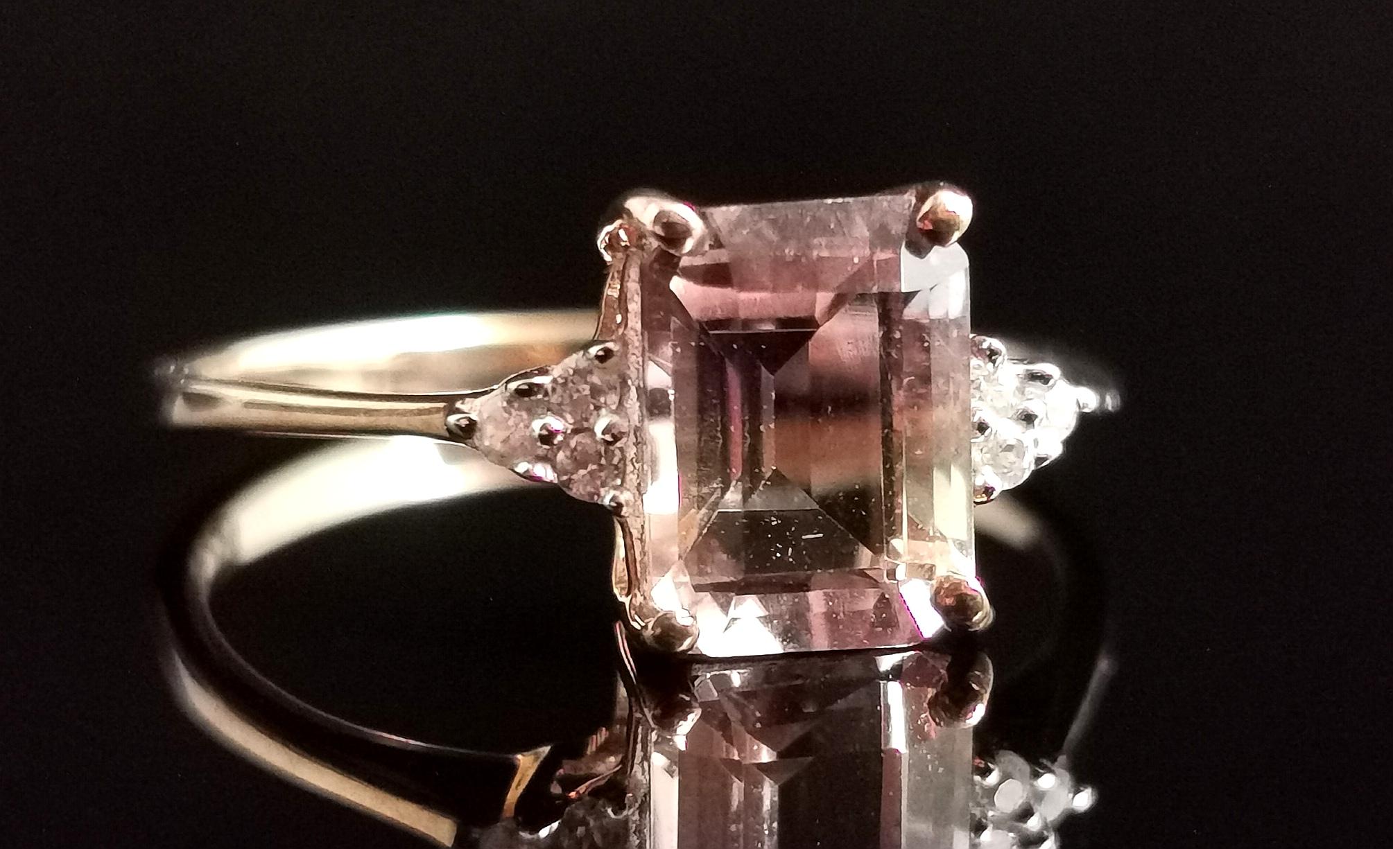 A Gorgeous vintage Ametrine and white zircon cocktail ring.

A beautiful purple and yellow, emerald cut Ametrine set to the front with sparkling white zircon chips either side adding a little sparkle and shine.

It has a smooth 9 karat yellow gold