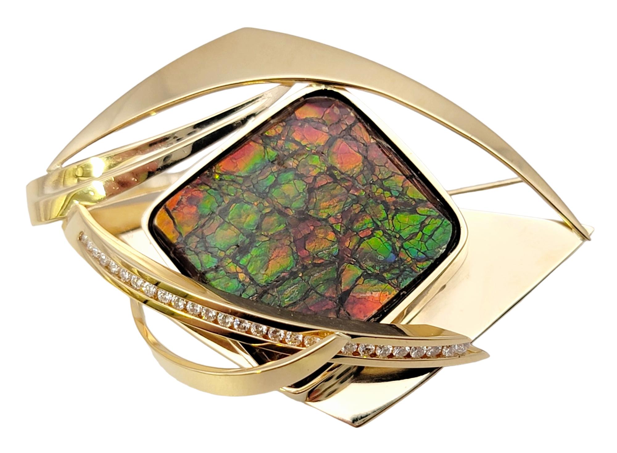 Captivating ammolite cabochon brooch adorned with dazzling natural diamonds. This radiant accessory effortlessly combines nature's rare gem and exquisite craftsmanship, resulting in a wearable work of art that is bound to mesmerize.

At the heart of
