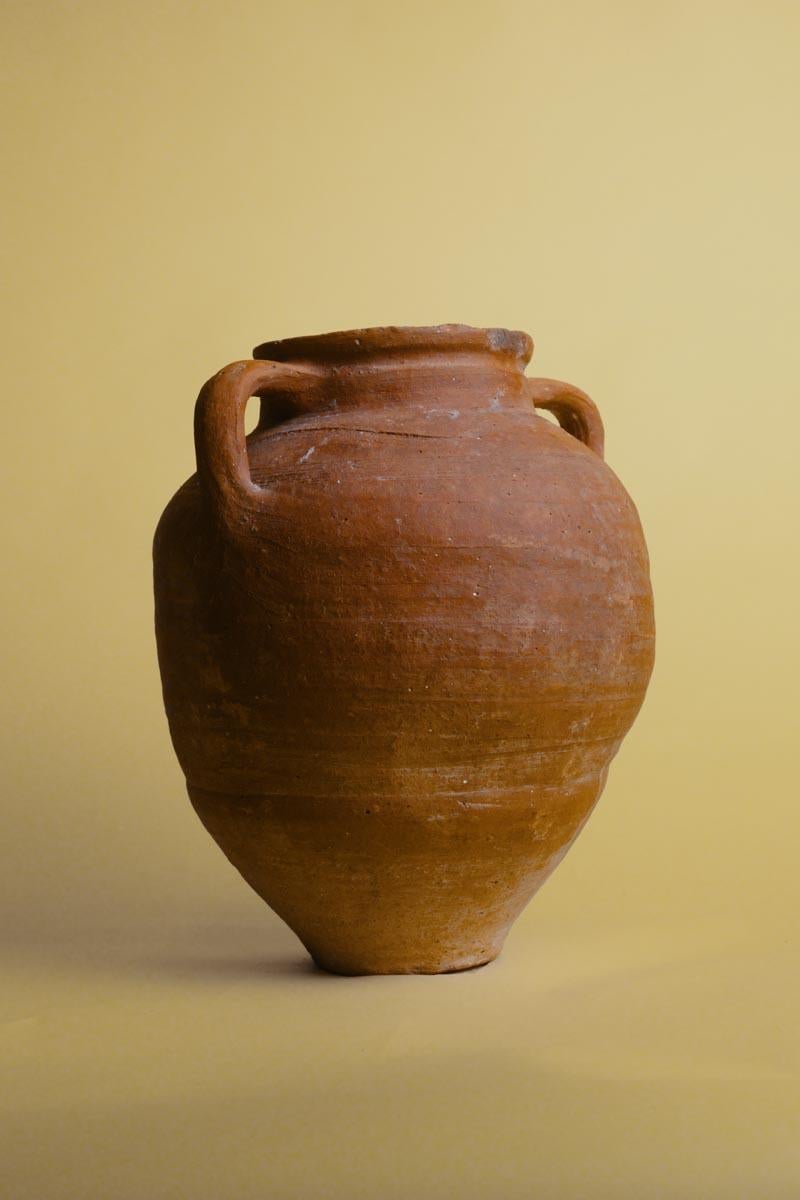 Esta vasija vintage de barro de Anatolia es una pieza cautivadora de la herencia turca, fabricada a mano en el corazón de Anatolia. Originalmente se fabricaba para guardar las provisiones domésticas, pero su historia se remonta a las tradiciones de