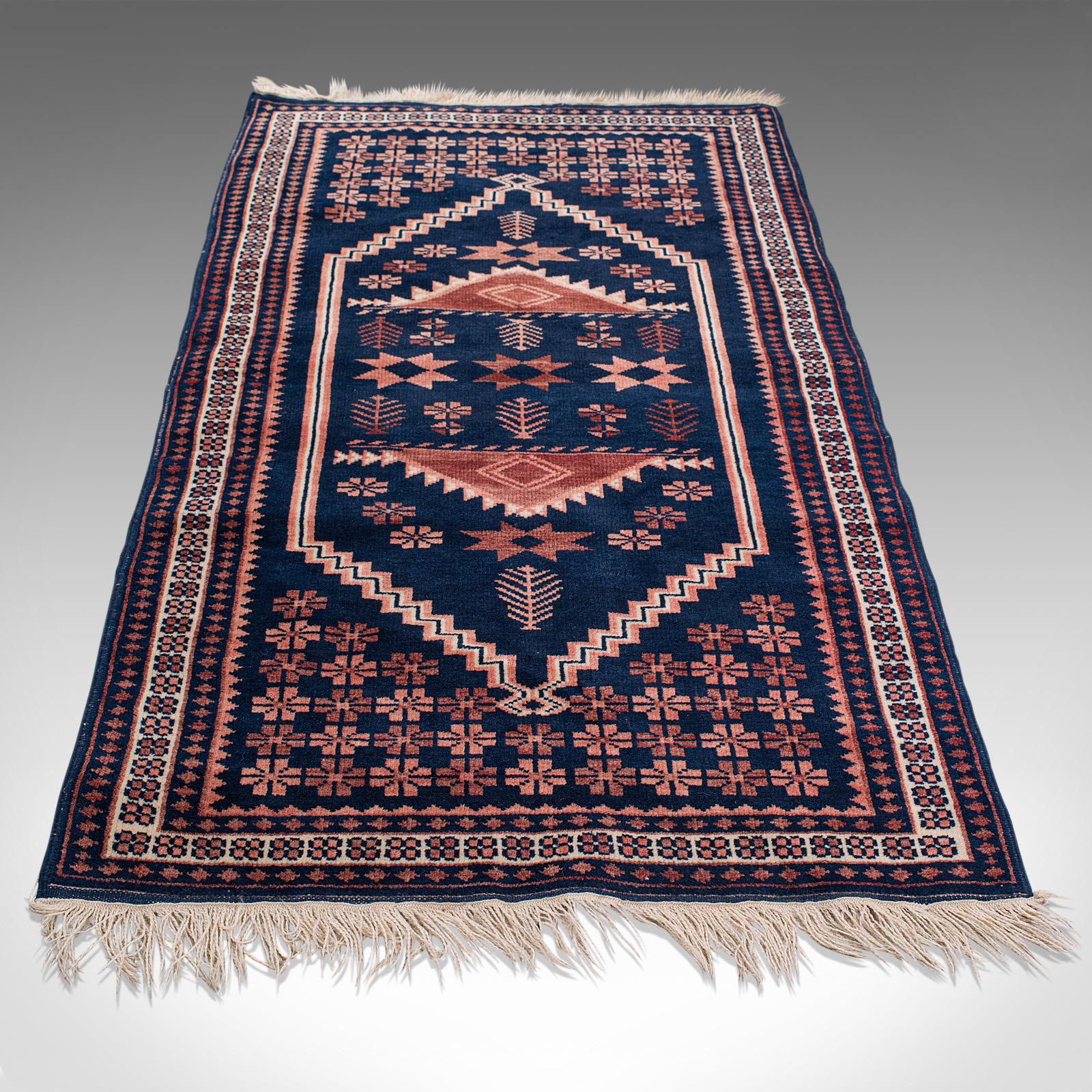 This is a vintage Anatolian hallway rug. A Turkish, woven carpet or wall covering, dating to the late 20th century, circa 1970.

Deep colors and fine detail
Displaying a desirable aged patina
Woven wool carpet of high quality
Pink and beige