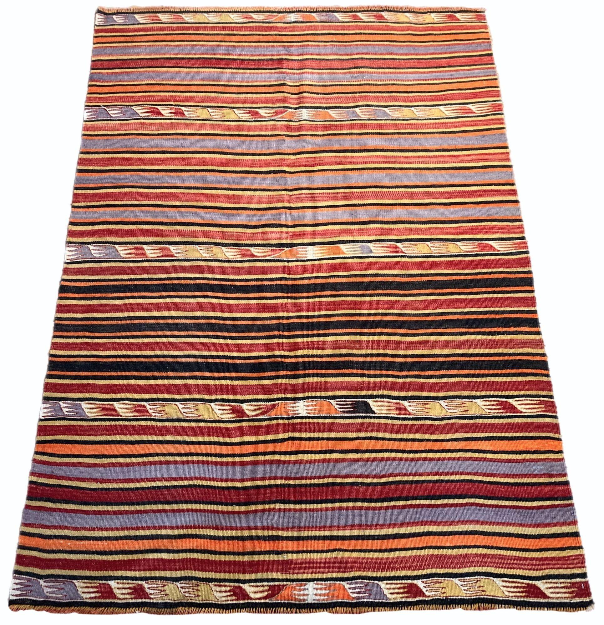 A beautiful vintage kilim, handwoven in central Turkey circa 1960 featuring a traditional multicoloured banded design in reds, blues and golds.
Size: 1.92m x 1.38m (6ft 4in x 4ft 6in)
This kilim is in good condition with light, age related wear.