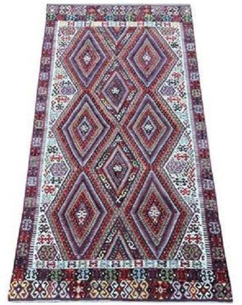 A stunning vintage kilim, handwoven in central Turkey circa 1940 with a geometric lozenge design and fabulous colours of reds, golds and aubergine. Very finely woven.

Size: 2.97m x 1.57m (9ft 9in x 5ft 2in)

This kilim is in very good condition