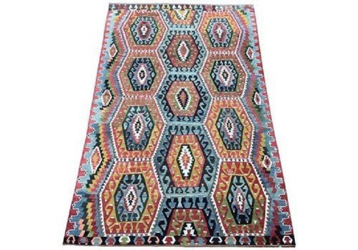 A stunning vintage kilim, handwoven in central Turkey circa 1940 with a geometric allover design on a terracotta field and fabulous secondary colours. Very finely woven.
Size: 3.06m x 2.03m (10ft x 6ft 8in)
This kilim is in very good condition