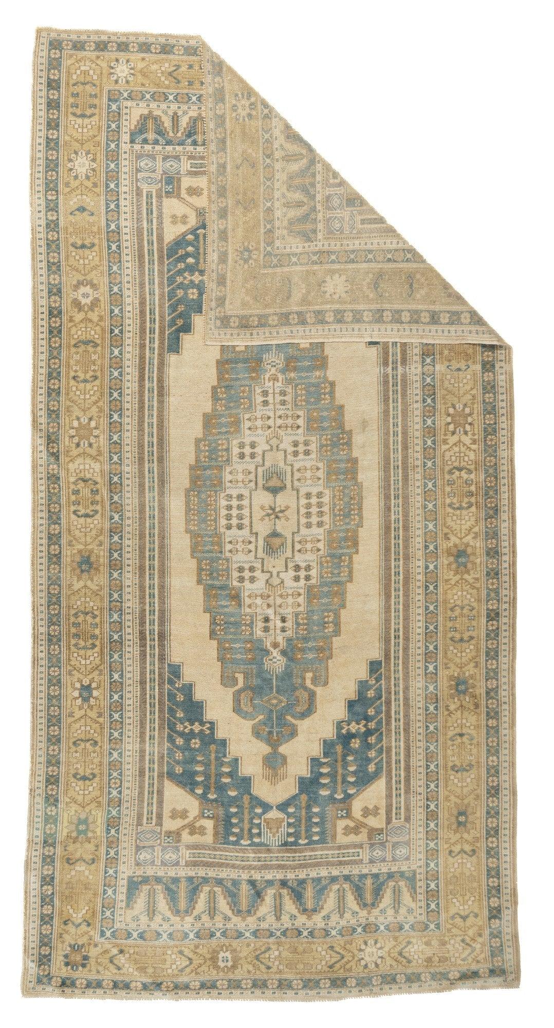 Vintage Anatolian Rug 5'11'' x 11'6''. This broad kellegi (long rug) format village Anatolian shows a very elongated and shallow-stepped medallion in sand, straw and denim blue; with dark blue conjoint spandrels, straw corners; and an etek (extra