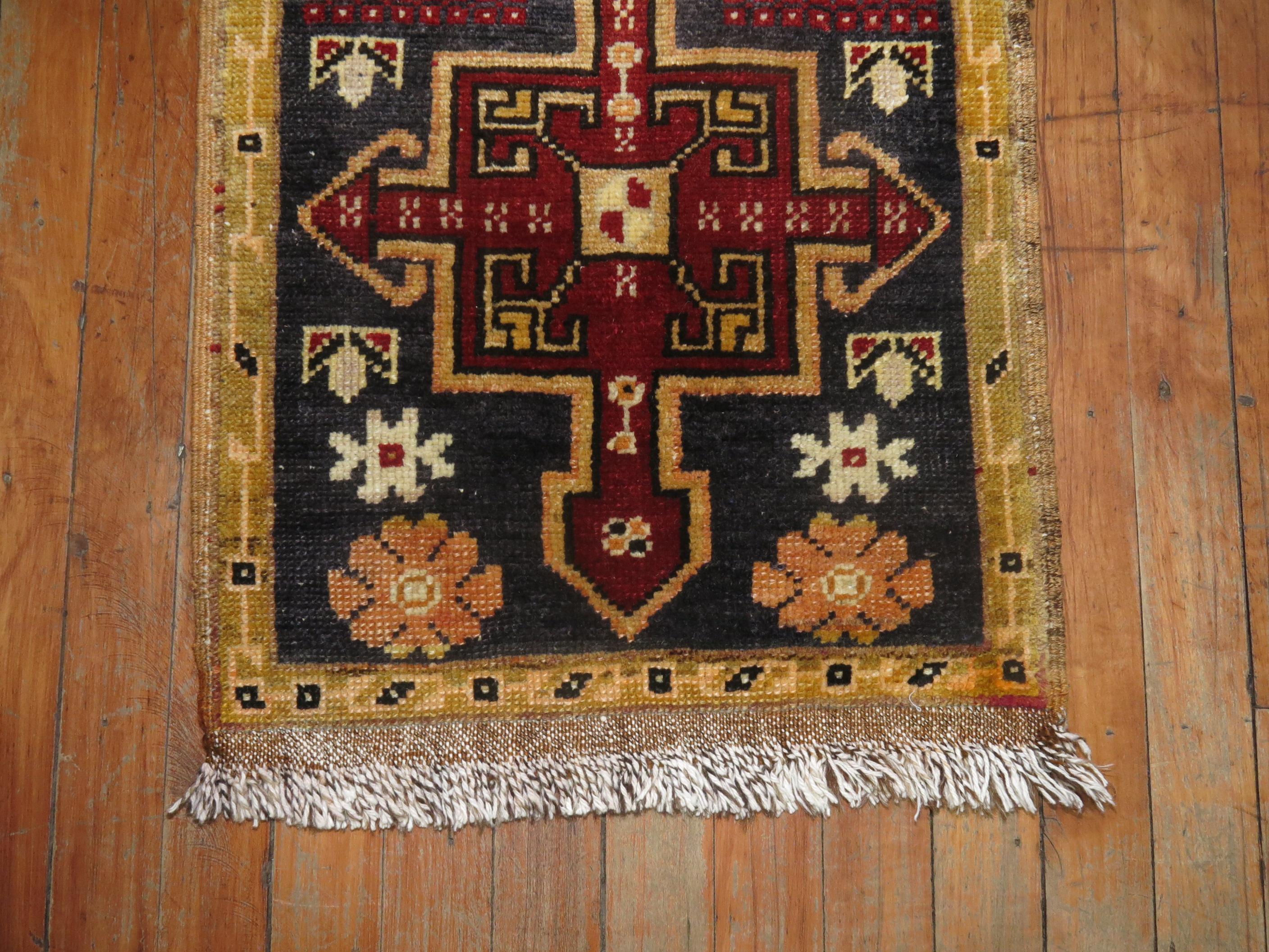 A one of a kind vintage Anatolian Turkish village rug with 2 red medallions on a charcoal field

1'7'' x 3'6''