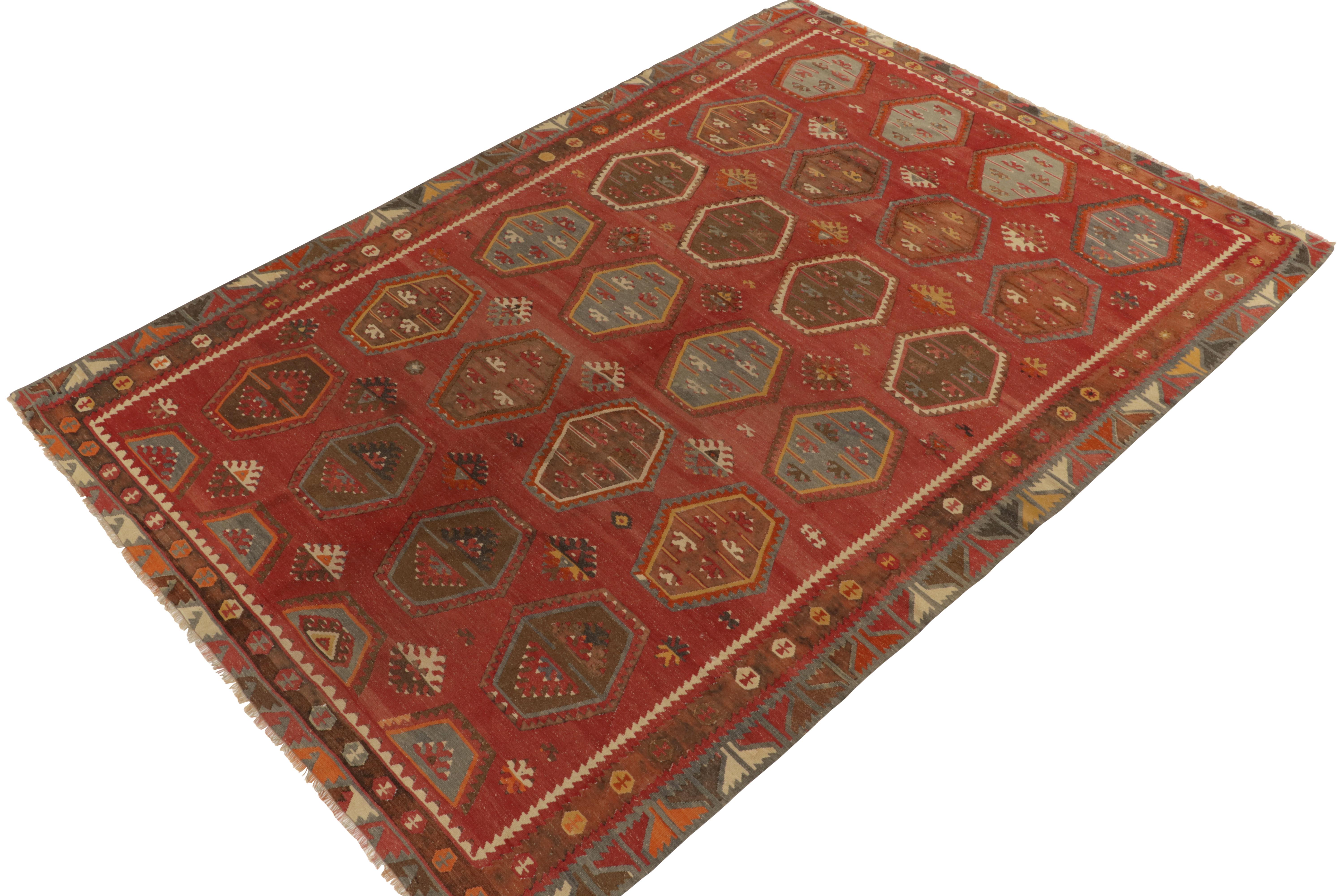 Originating between 1950-1960, a rare 8x11 vintage kilim rug believed to hail from the Sarkisla lineage of Turkey. 

Handwoven in wool, the tones of red, beige-brown and blue play harmoniously together for a rustic tribal appeal in the field’s