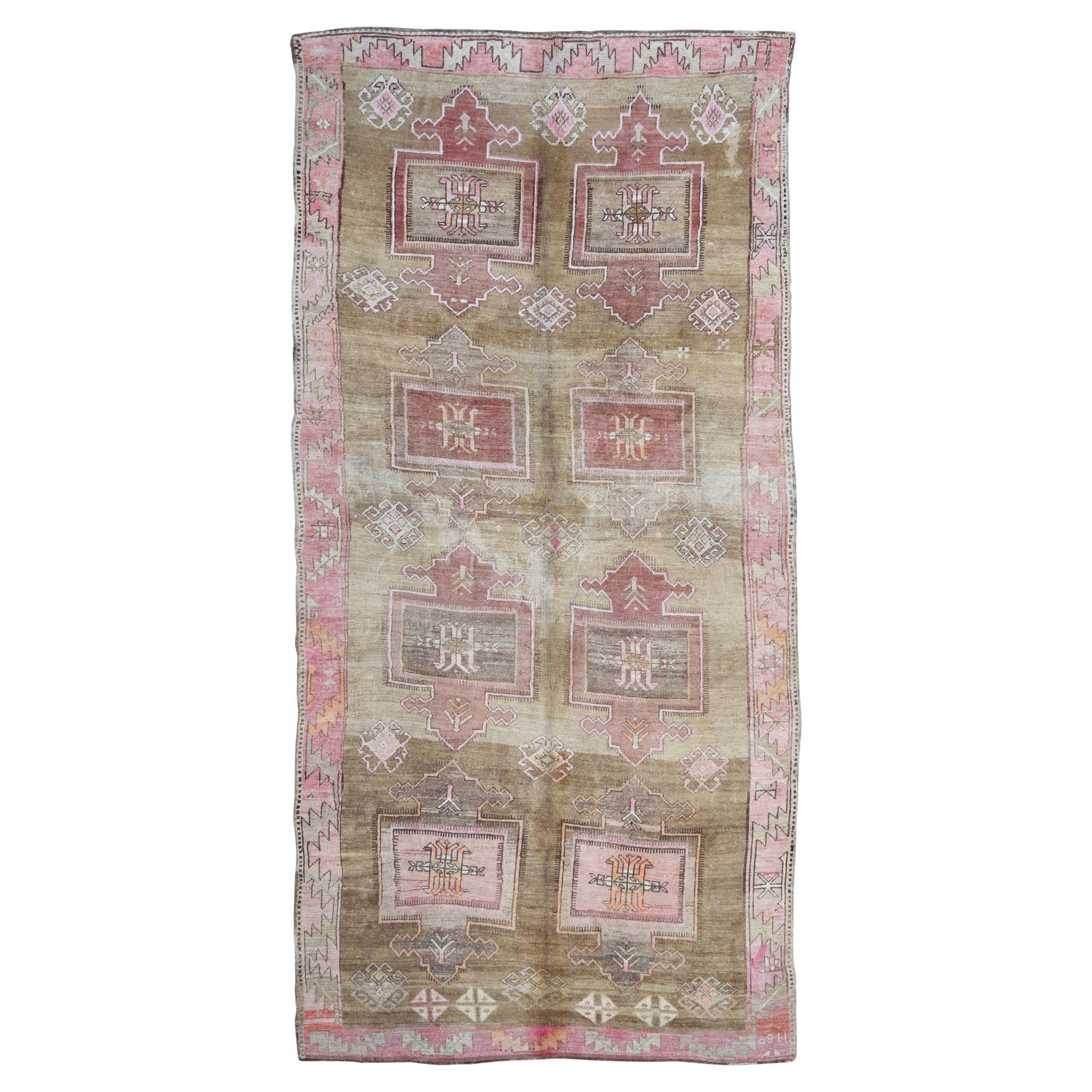 This vintage hand-knotted wool rug is a captivating example of tribal textile artistry, offering a bold geometric composition softened by time and wear. Its grand proportions make it an ideal anchor for large living spaces, dining rooms, or