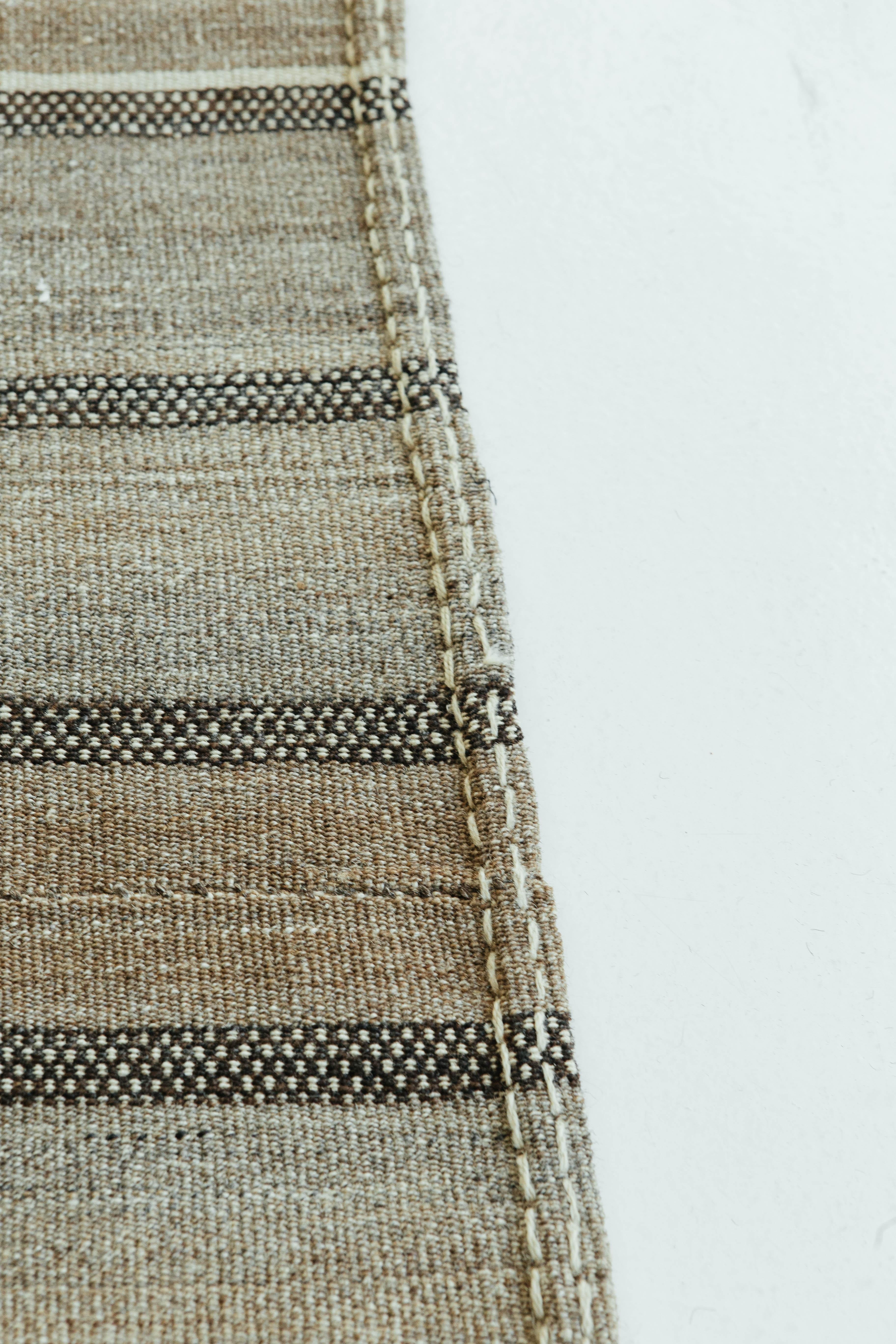 A gorgeous vintage Anatolian Turkish flat-weave banded in natural ivory, peachy tan, and brown stripes. The varying degrees of stripes create a simple yet interesting design for a wide variety of interiors. Vintage Turkish Anatolian rugs weave