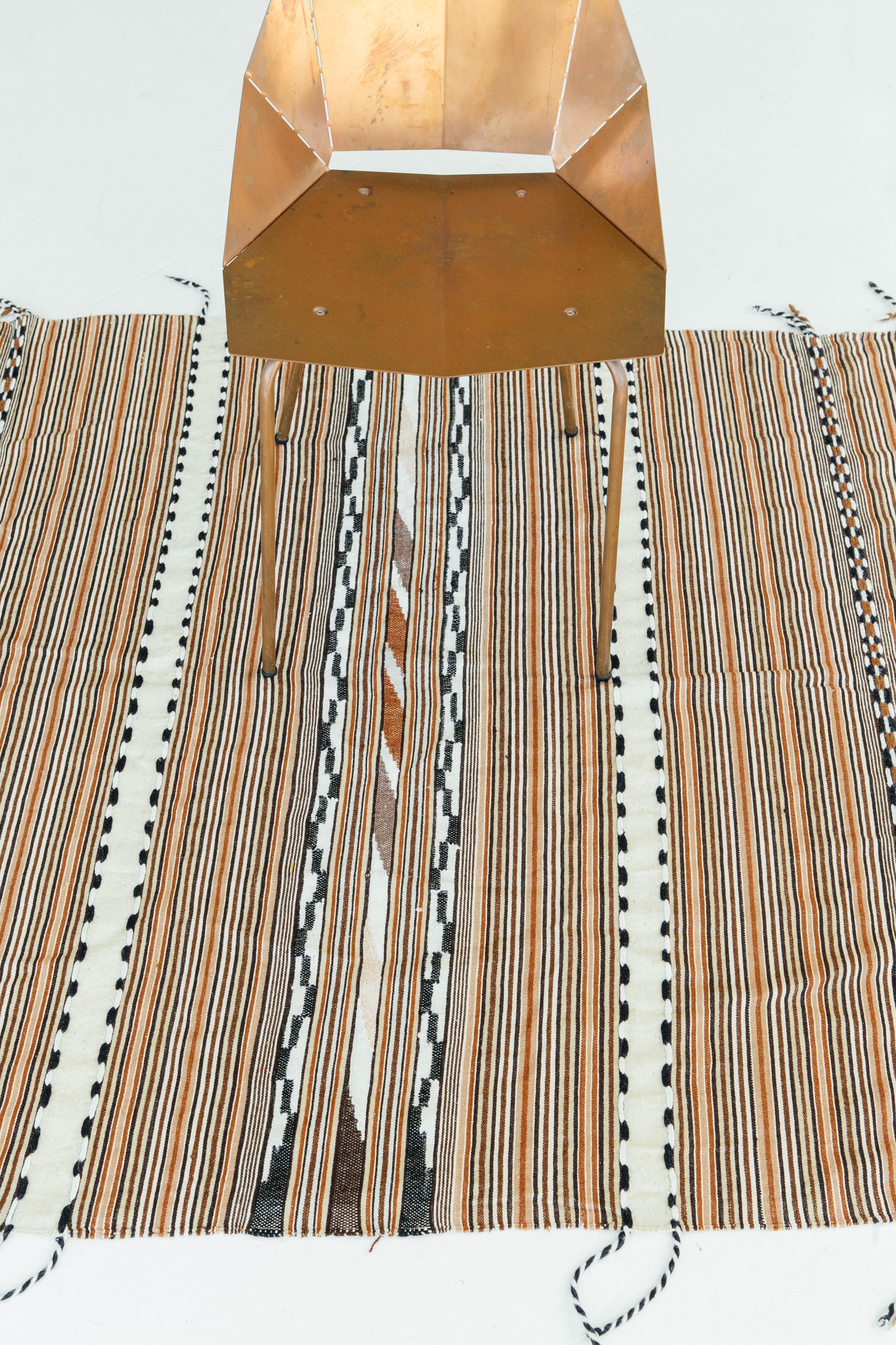 A gorgeous vintage Anatolian Turkish flat-weave banded in neutral and warm colors. The varying degrees of stripes and tribal designs create an interesting design for a wide variety of interiors. Vintage Turkish Anatolian rugs weave together dyes and