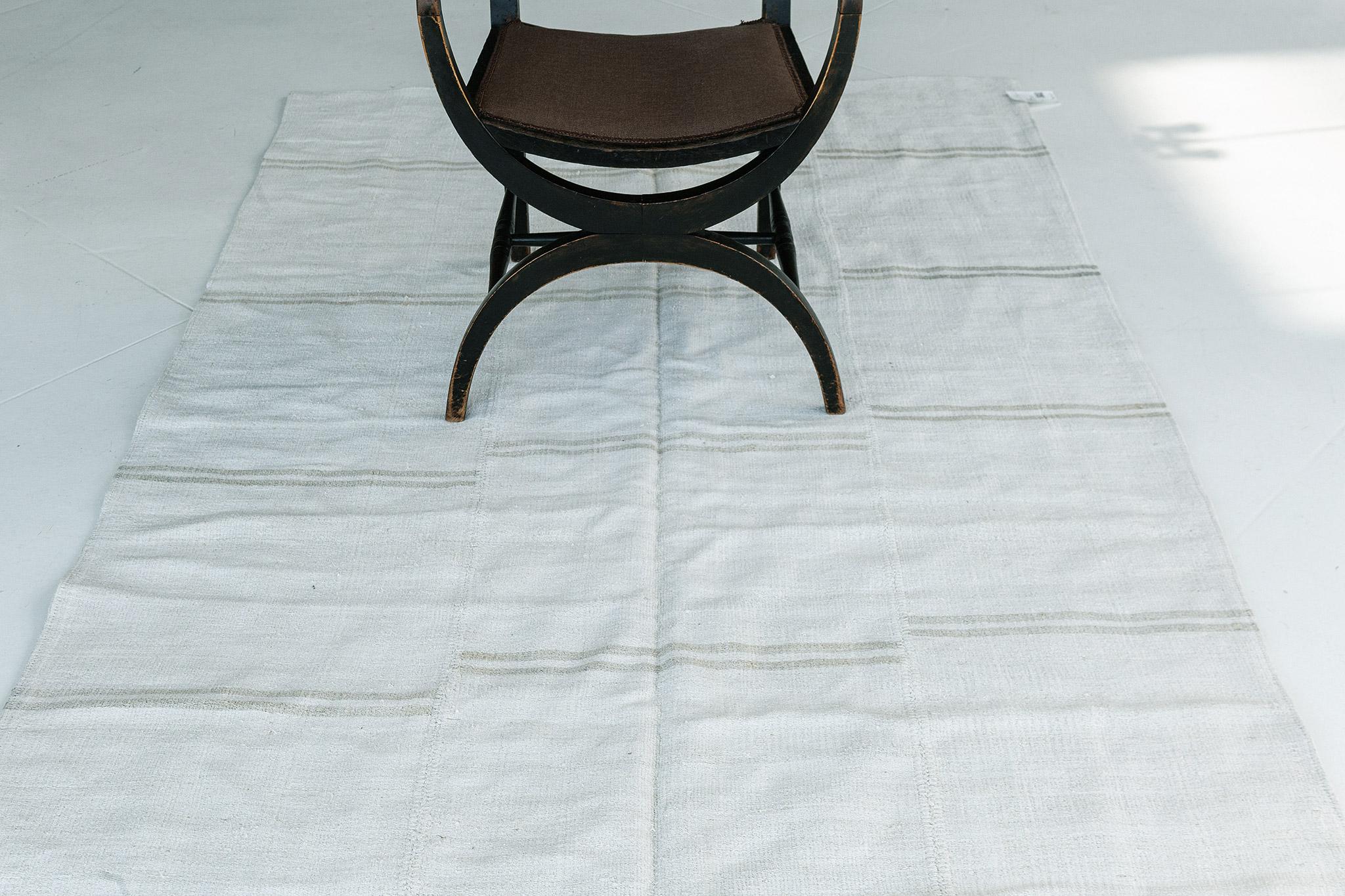 A gorgeous vintage Anatolian Turkish flat weave banded with soft black stripes. The varying degrees of stripes create a simple yet interesting design for a wide variety of interiors. Vintage Turkish Anatolian rugs weave together dyes and colours,