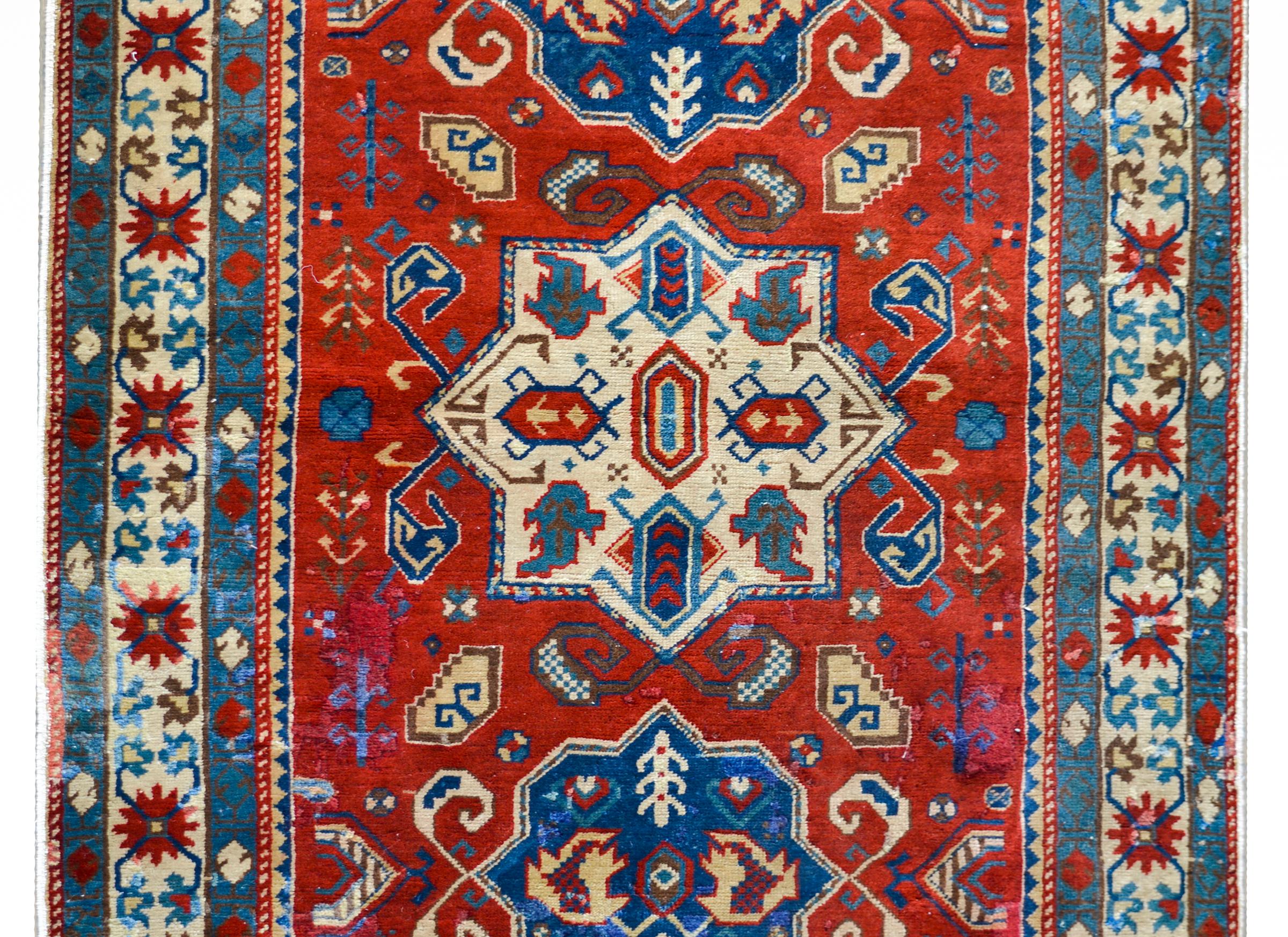 A wonderfully bold vintage Anatolian Turkish rug with three large central floral medallions, each with more leaves and flowers, and living amidst a field of more flowers and leaves, all surrounded by three petite floral partnered stripe borders.