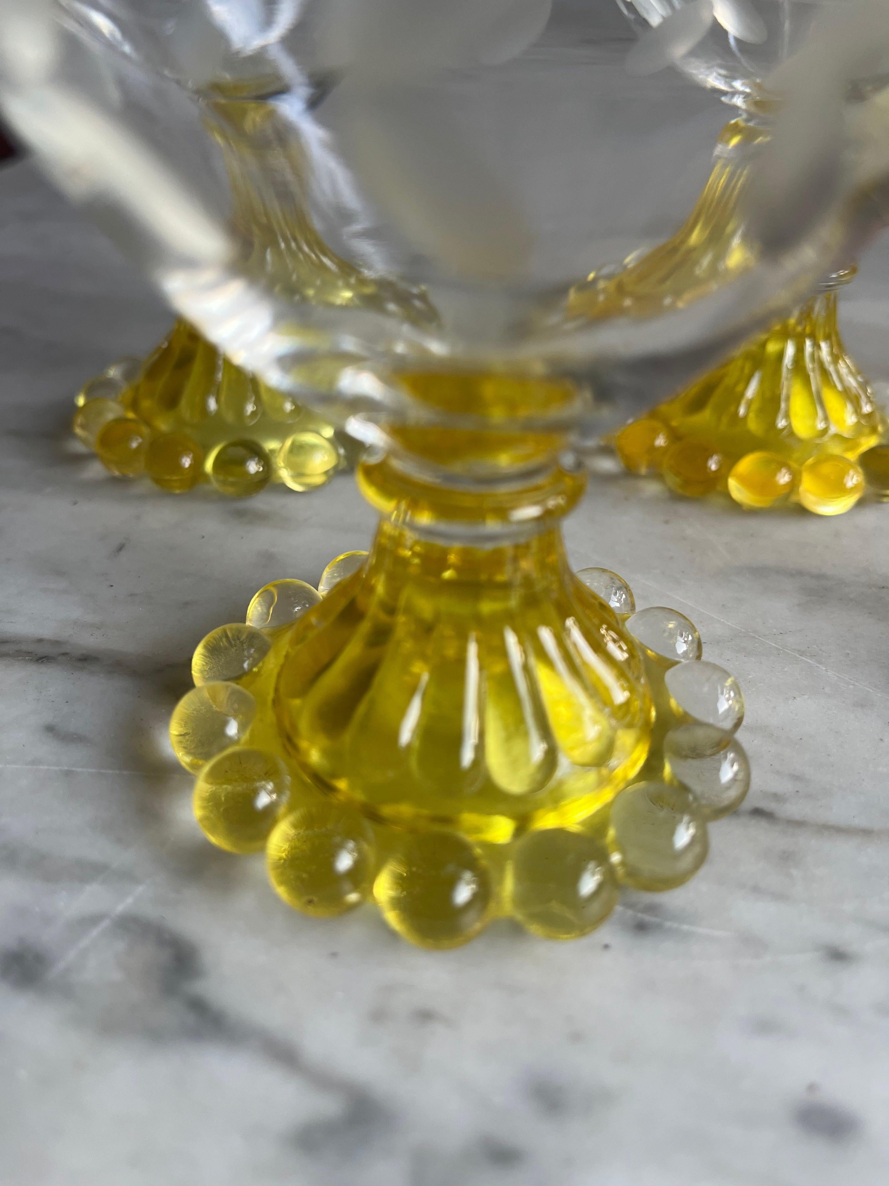 Indulge in the elegance of yesteryear with this set of 6 Anchor Hocking Boopie Bubble Sherbert dishes, where vintage flair meets versatile use. The vibrant yellow base and delicate laurel etching beckon celebrations and sweet treats alike. Perfectly
