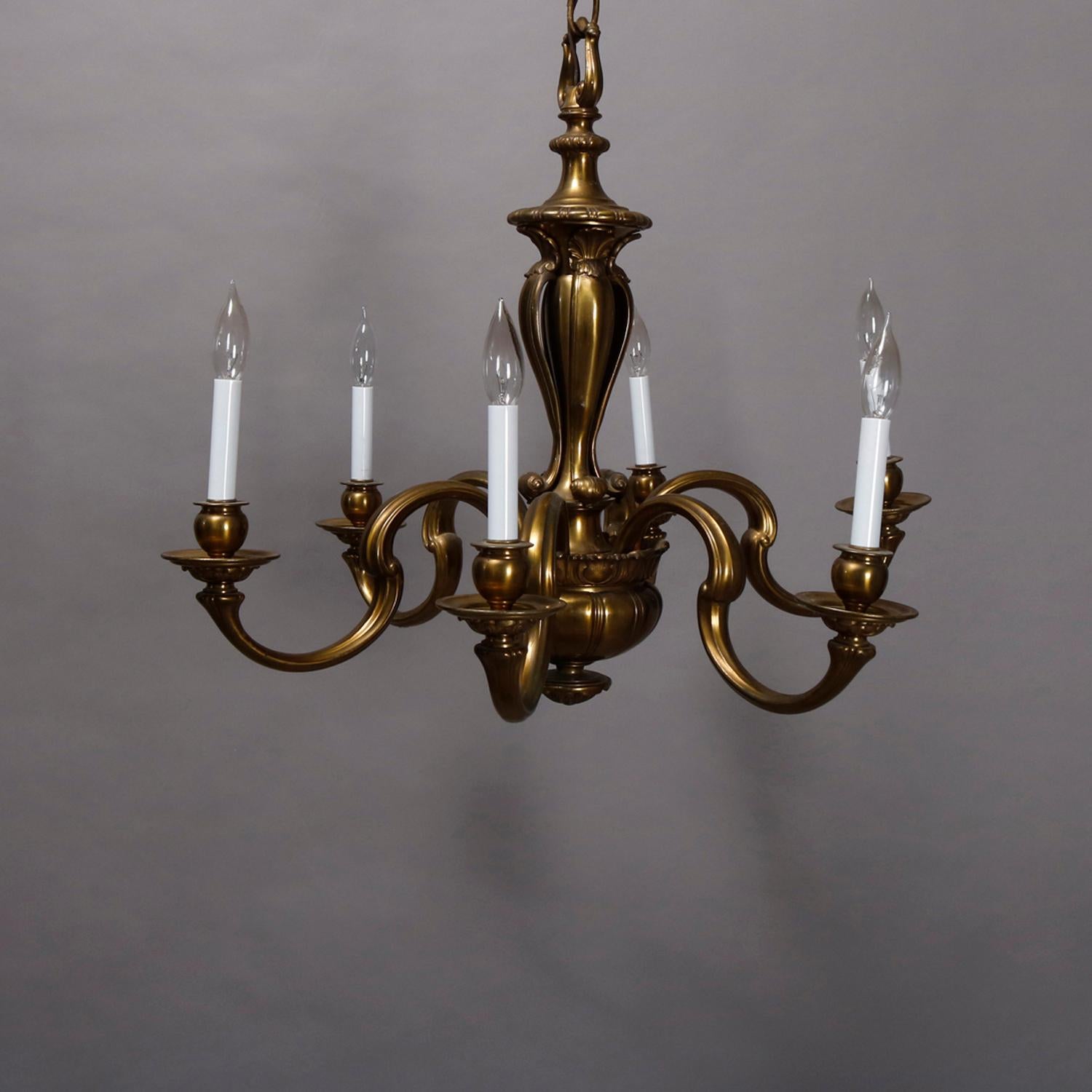A vintage and large French Empire style chandelier offers bronze frame with urn form column having six S-scroll arms terminating in candle lights and surmounting melon form drop finial, circa 1940.

Measures- 27