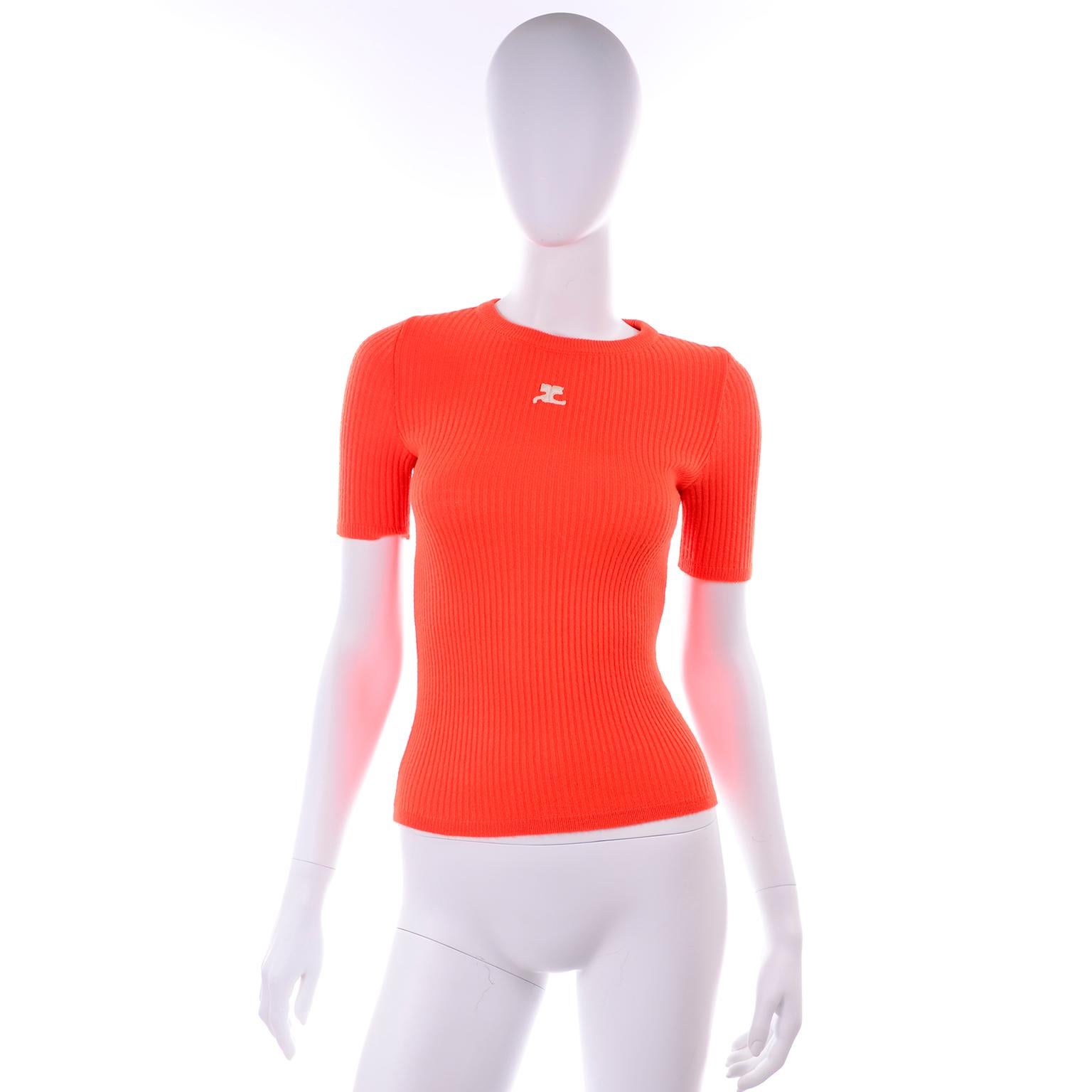 This is a great 1970's vintage Andre Courreges orange ribbed short sleeve top with the embroidered Courreges logo on the front.  This top is labeled a size A or small, and is made in a soft acrylic that has some stretch.  We estimate it to fit a