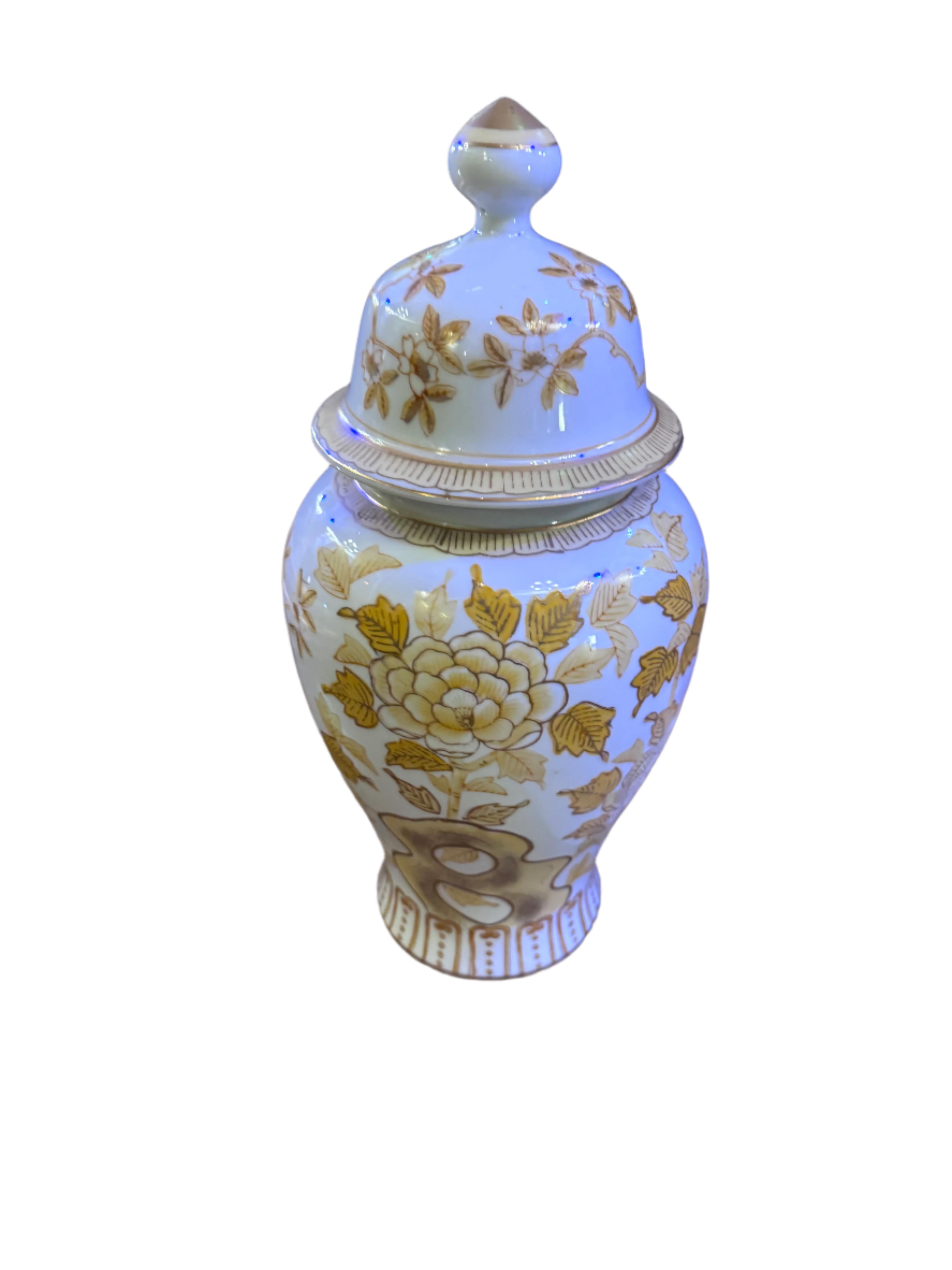 Vintage Andrea by Sadek Porcelain Japanese Gold/Yellow Lidded Chinoiserie Ginger Jar Vase

Perfect for enhancing your home decor or as a gift, this vase/urn is a timeless addition that will elevate any space with its charm and artistry. The face has