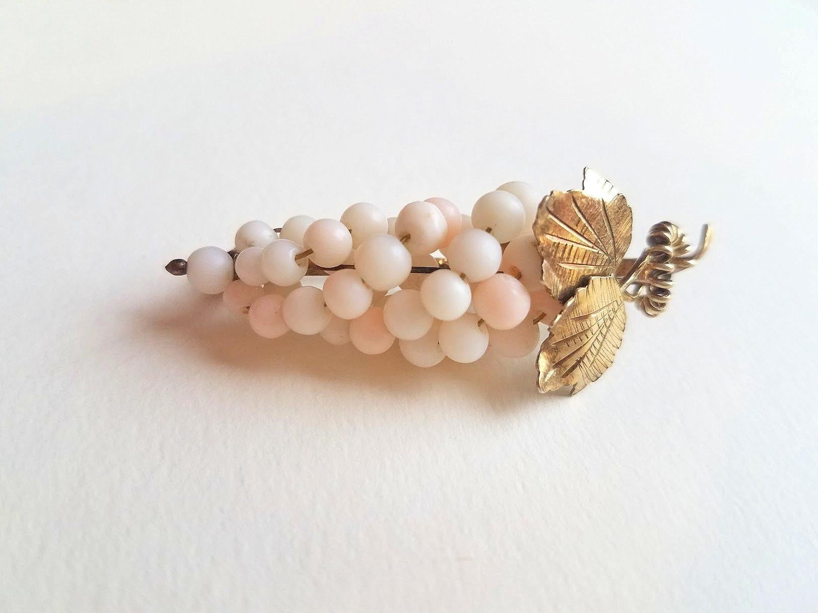 Introducing our exquisite Angel Skin Coral Grapes Brooch that is sure to add a touch of elegance to your collection.

Measuring at 2 inches (5 cm) tall with a leaf span of just under 7/8