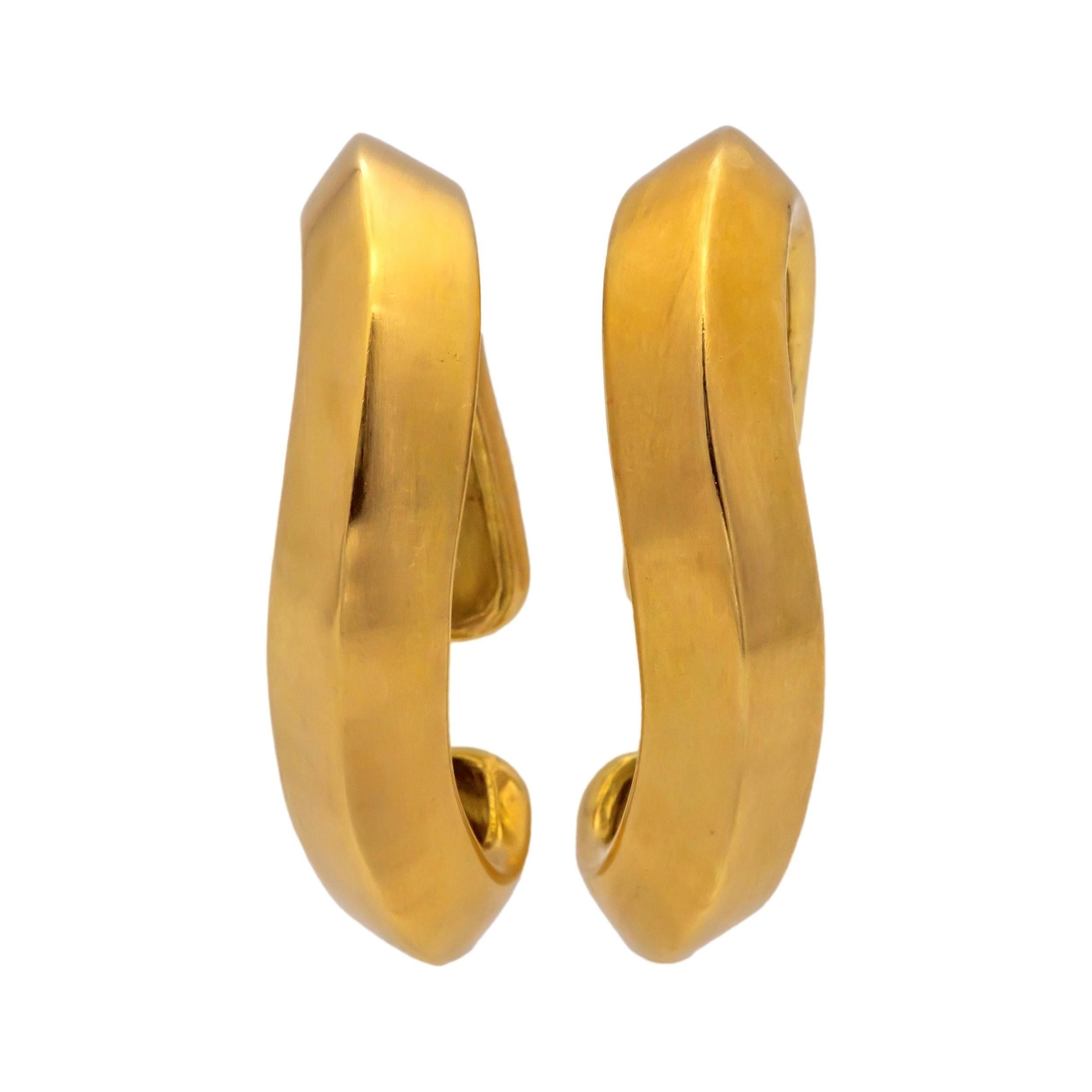 These Angela Cummings Cuff Earrings are crafted in 18K yellow gold, featuring a bold, curved Knife Edge open cuff design. The sleek and modern sculptural form showcases Cummings' signature style from the 1980s and embodies her innovative approach to