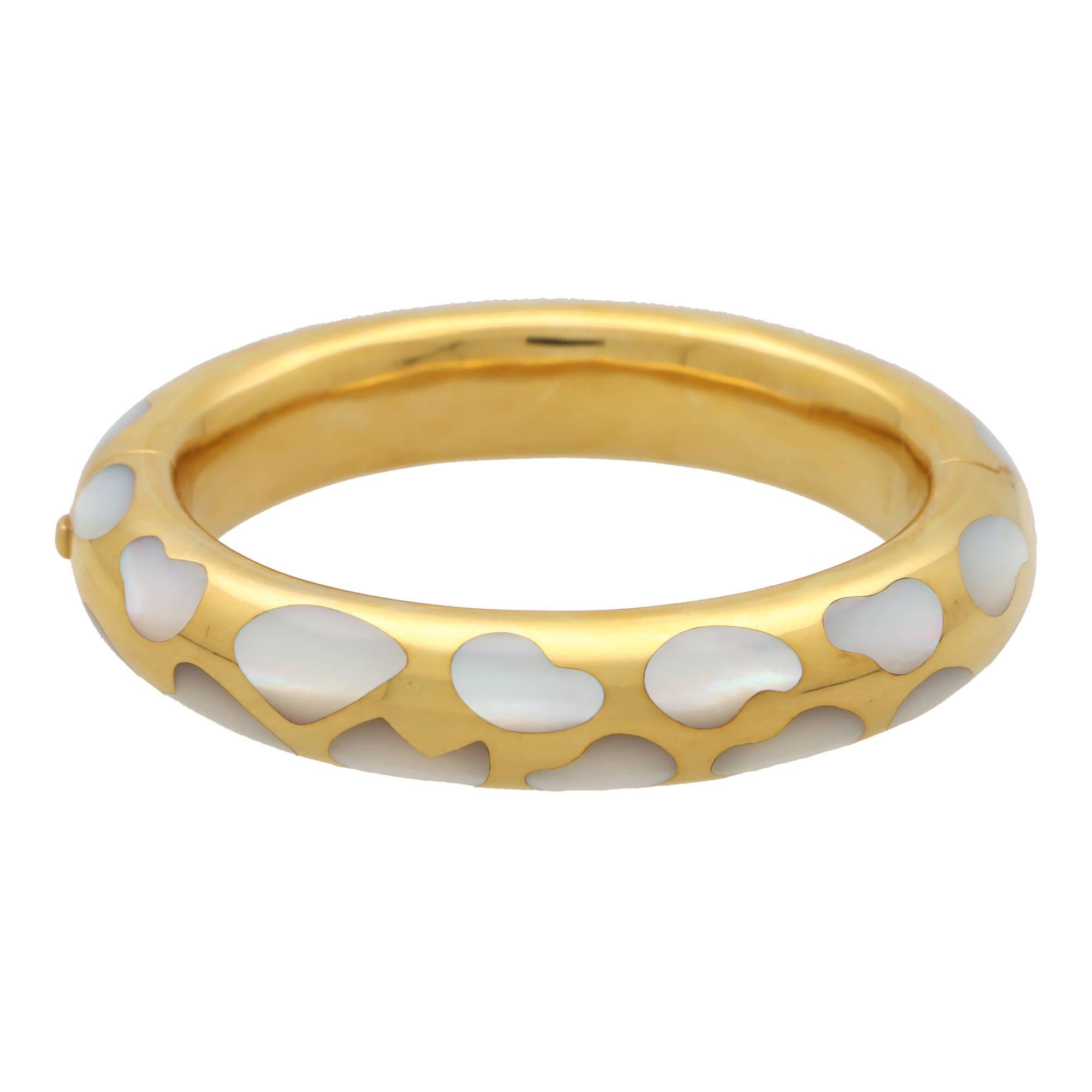 
A beautiful vintage Angela Cumings for Tiffany & Co. mother of pearl bangle, set in 18k yellow gold.

From the now discontinued ‘Allure collection’ by Angela Cummings for Tiffany & Co., the bangle is composed of a chunky yellow gold band. The