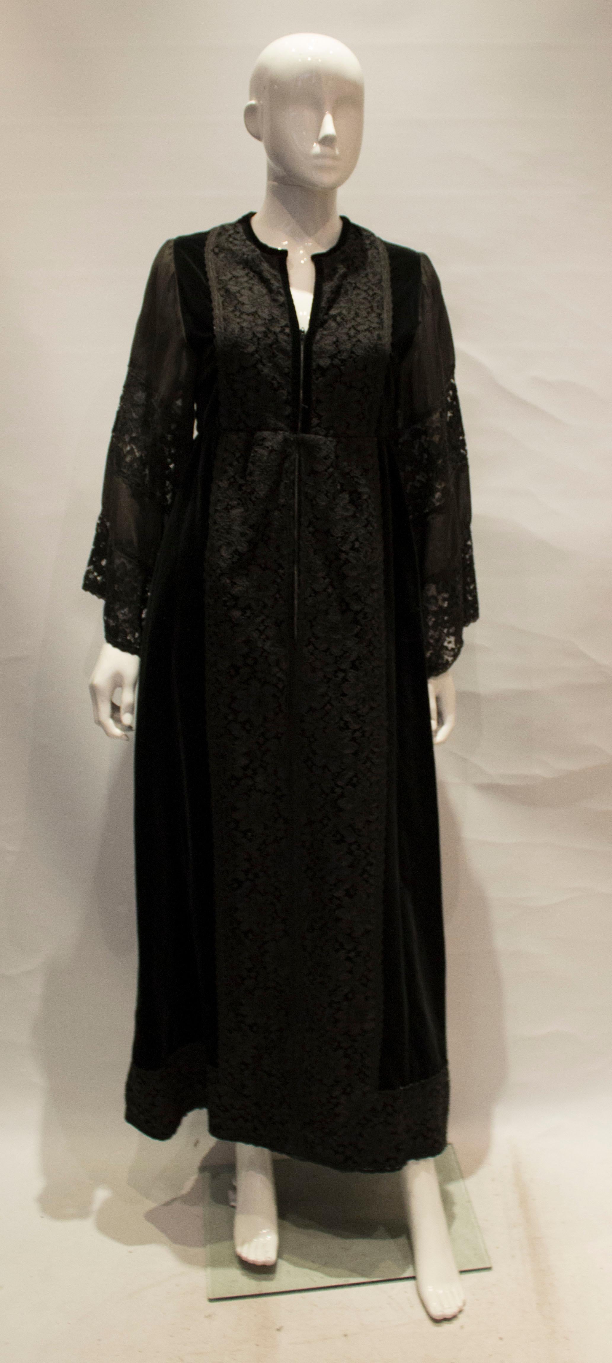A great vintage gown for Fall by Angela Gore. The dress has a v neckline, with velvet and lace panels with a front zip opening and is fully lined.