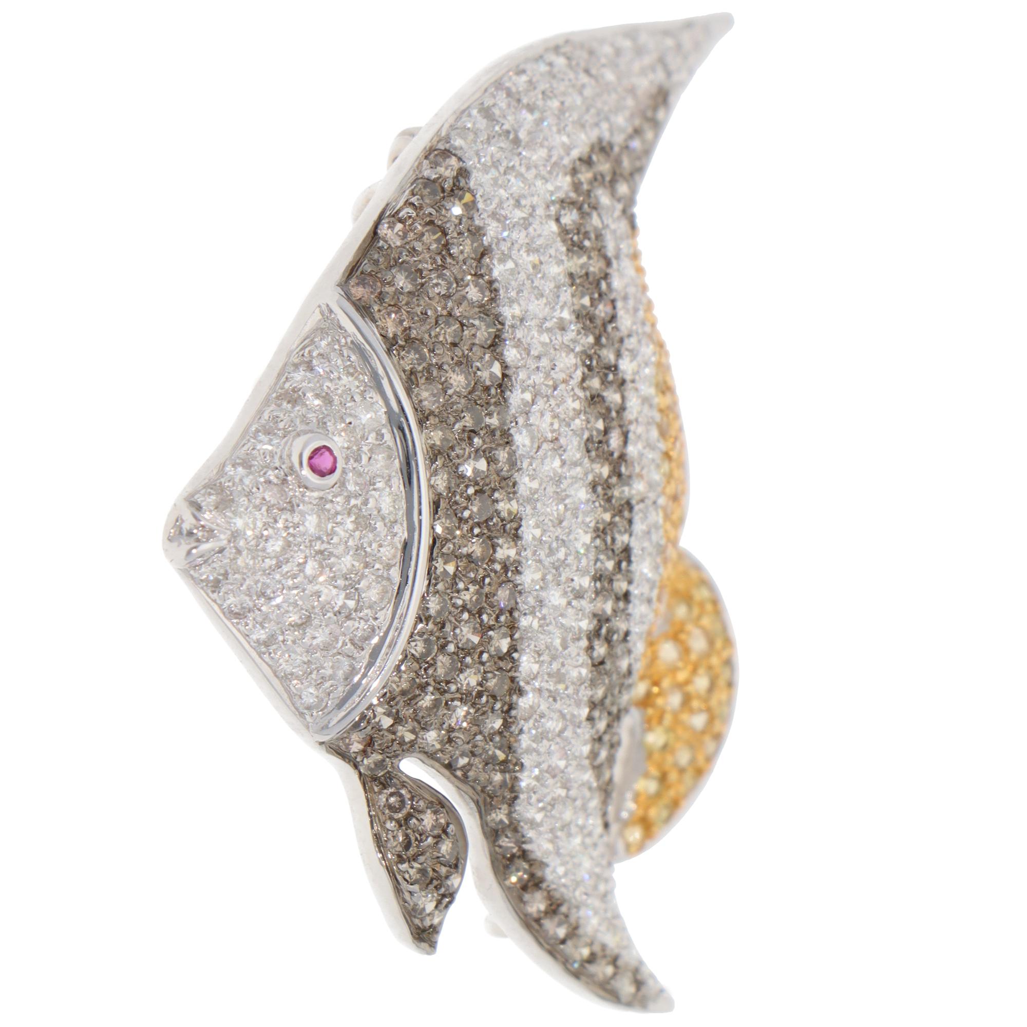 A beautiful vintage angelfish diamond and yellow sapphire brooch set in 18k white gold.

The brooch depicts an angelfish motif with a yellow tail. It is pavé set with round brilliant-cut diamonds and yellow sapphires and adorned with a red ruby eye.