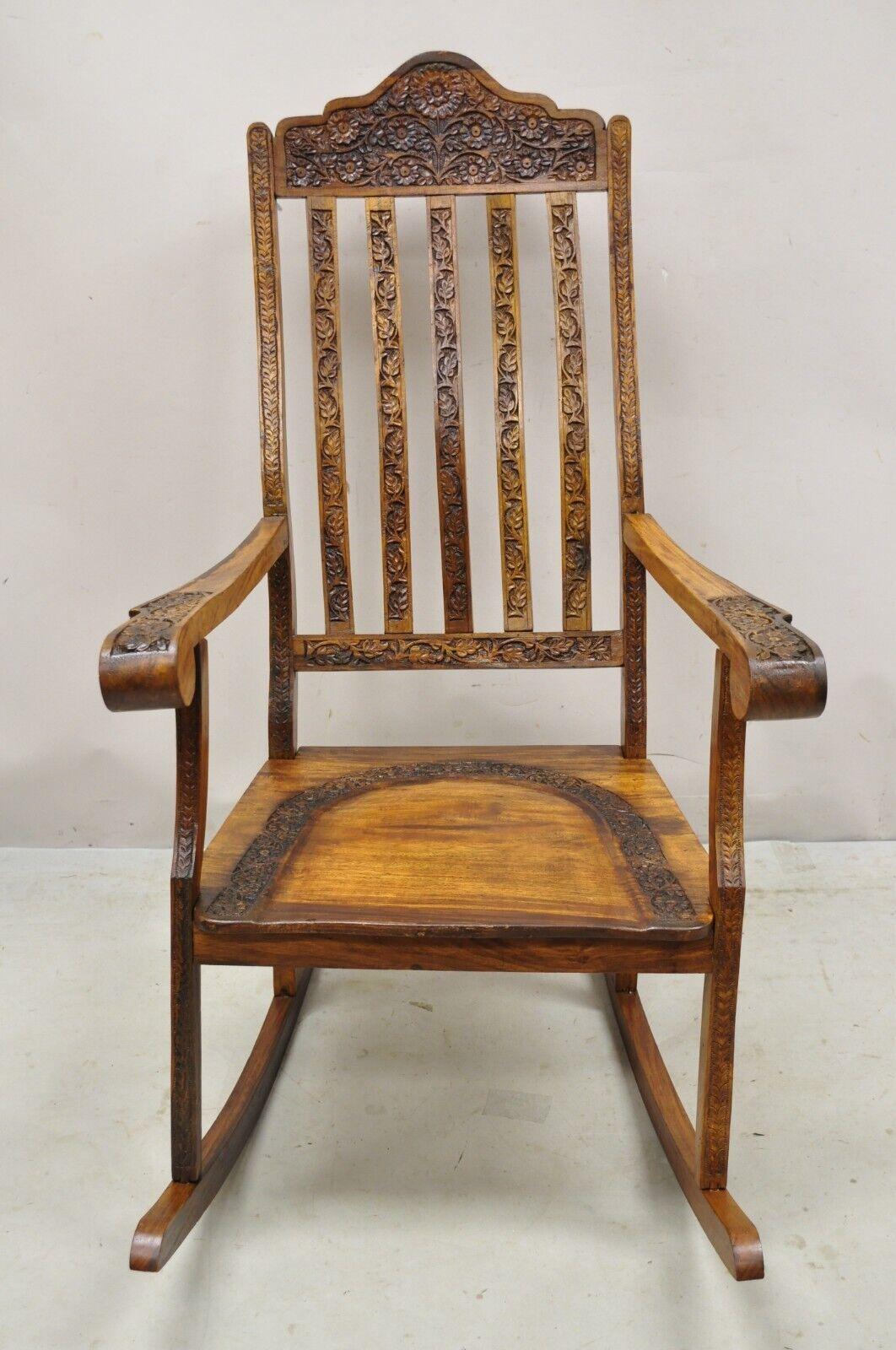 Vintage Anglo Indian carved teak wood rocking chair rocker. Item features a solid wood frame, beautiful wood grain, nicely carved details, very nice vintage item, great style and form, circa Mid-20th Century. Measurements: 42.5