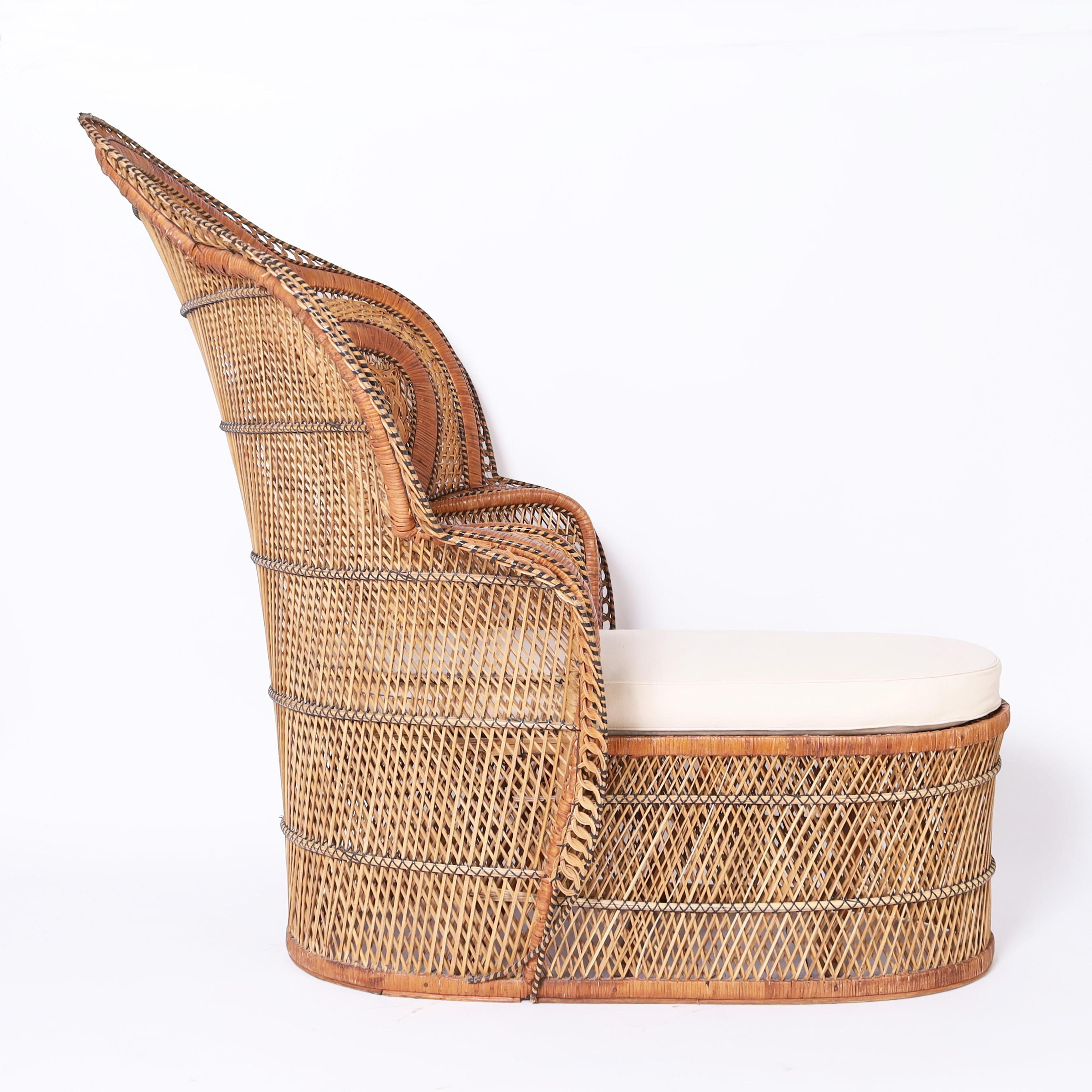 Rare and unusual Anglo Indian recamier lounge handcrafted in wicker and rattan with a peacock or cobra back and leg rest extension featuring plenty of exotic come hither appeal.