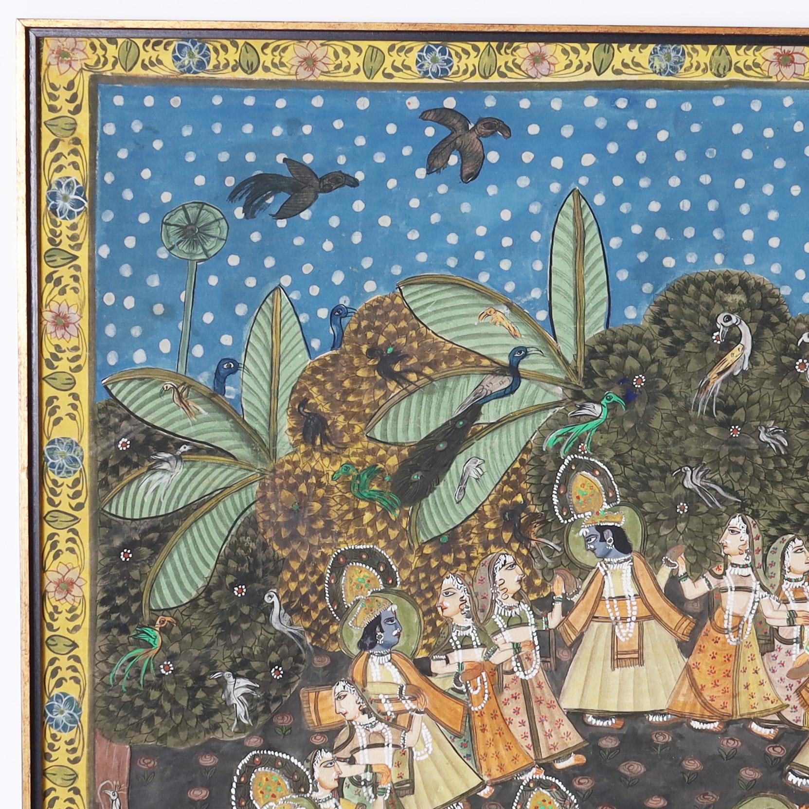 Enchanting vintage Anglo Indian Pishhwai gouache painting on cloth mounted on board, steeped in alagorical context, depicting Krishna dancing with villagers in a background of birds and trees. Presented in the original mahogany frame.