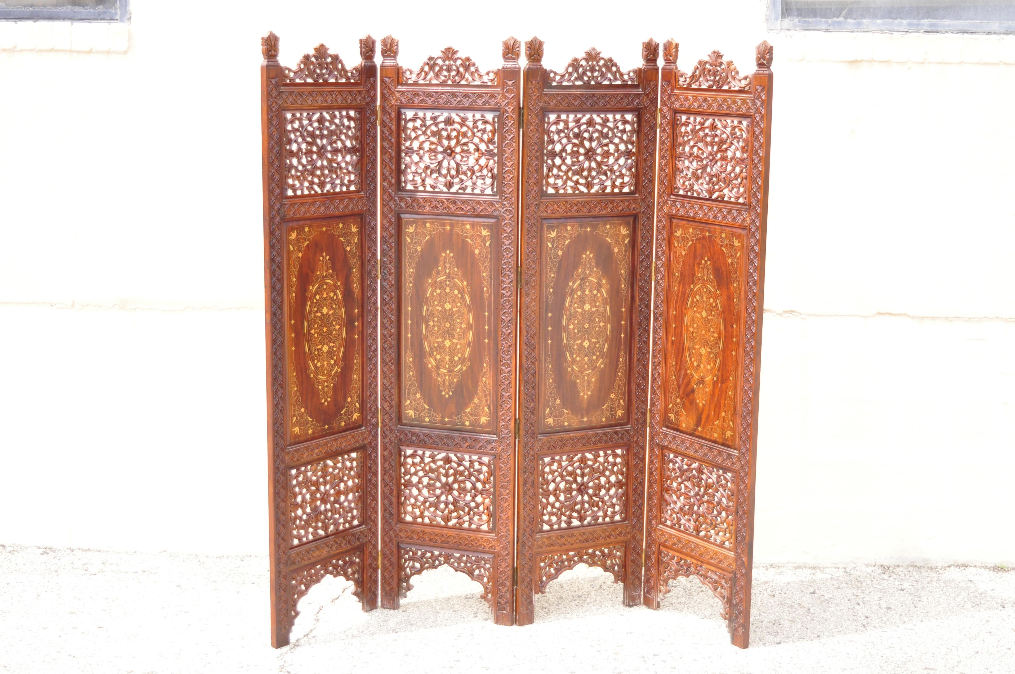 Vintage Anglo-Indian teak wood brass inlay 4 panel room divider folding screen. Item features ornate brass inlay, 4 folding panels, nicely carved details, very nice vintage item, great style and form. Circa mid to late 20th century. Measurements: