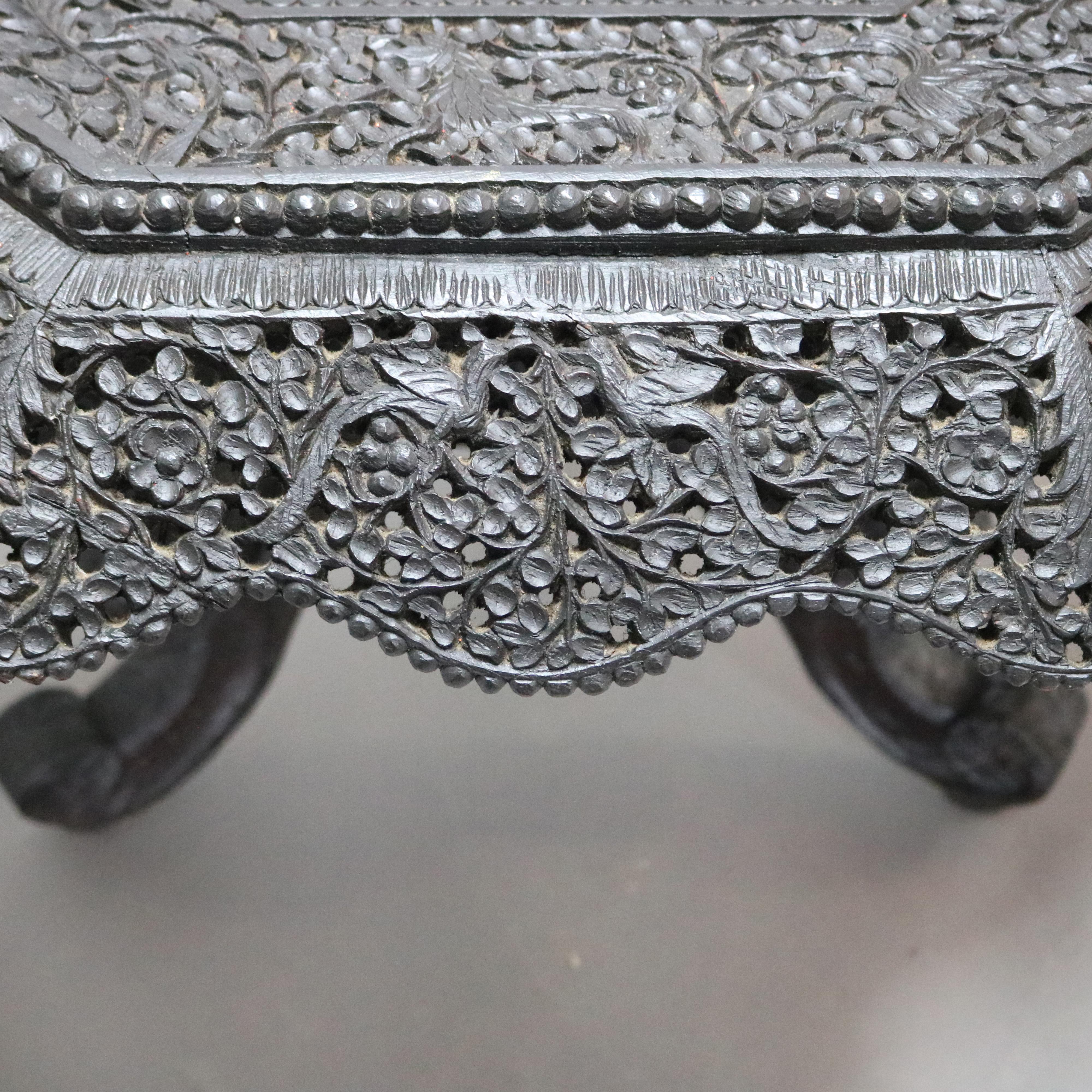 A vintage Anglo Italian low table offers octagonal form with carved rosewood in foliate, animal and bird figures over pierced skirt of the same, surmounting acanthus carved column raised on scroll form cabriole legs with lions, circa