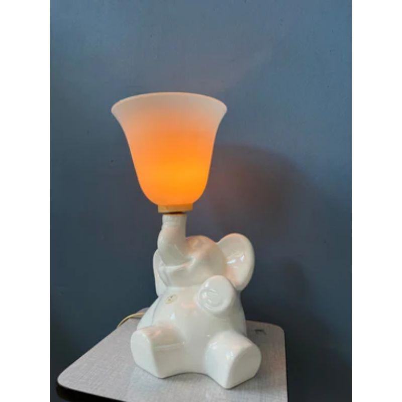 Rare porcelain elephant lamp with a glass shade. The horn-like shade can attached to the porcelain elephant separately. The lamp requires an E27 lightbulb and currently has an EU-plug.

Dimensions:
Height: 36 cm
Width: 23 cm
Depth: 30 cm

Condition: