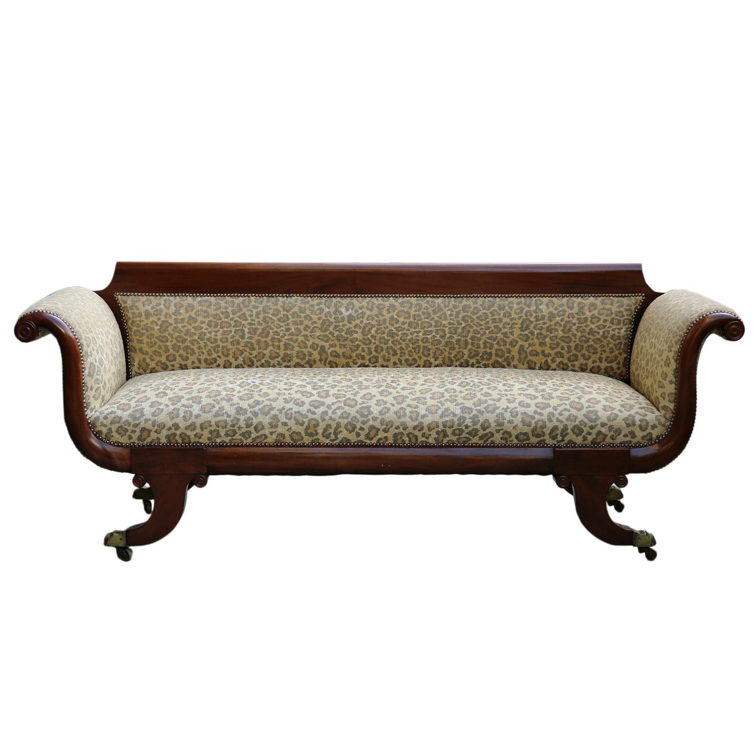 A vintage animal pattern chaise lounge on brass footed casters. With an arm height of 30
