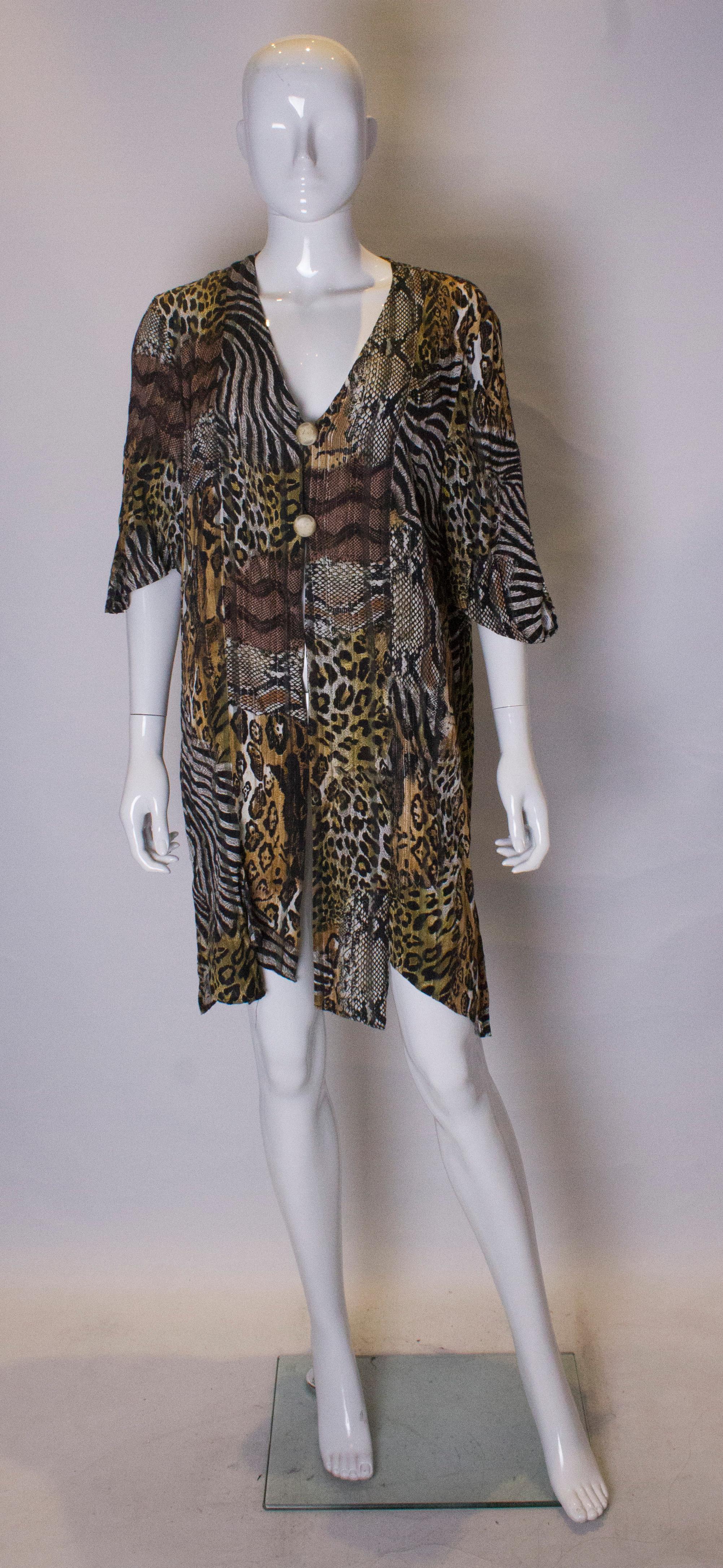 An easy to wear vintage  jacket /mini dress in an attractive animal print. The jacket has short sleaves , a two button fastening, v neckline and 4 '' slits at the front and back. It is unlined. Measurements: Bust  up to 40'', length 38''